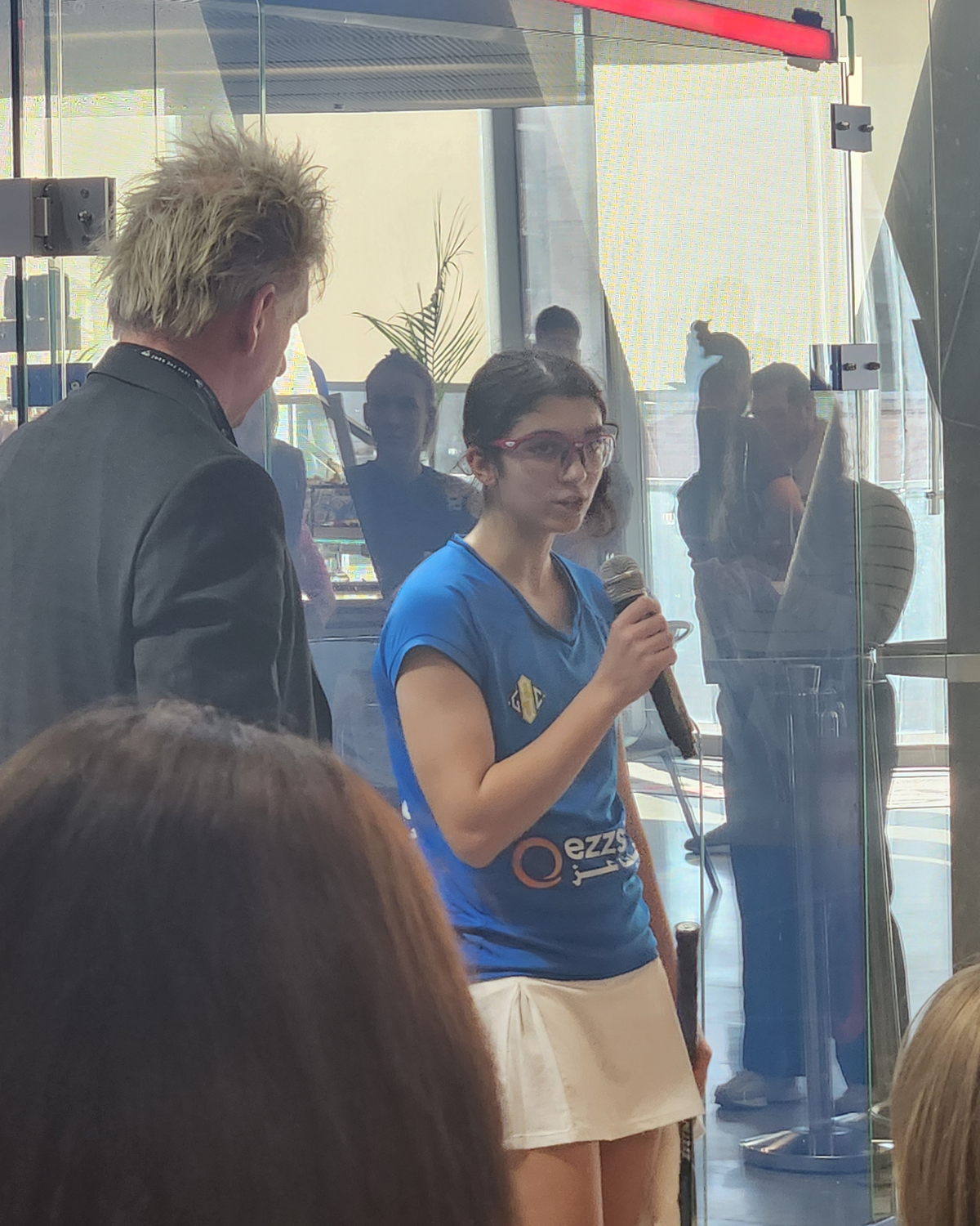 Amina Orfi speaking after a squash match in Washington DC, February 2024