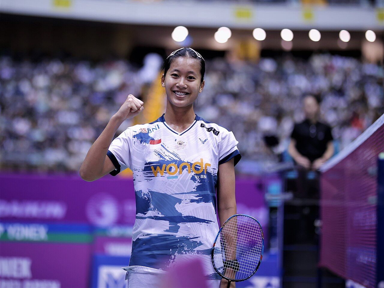 Putri Kusuma Wardani celebrating on a badminton court