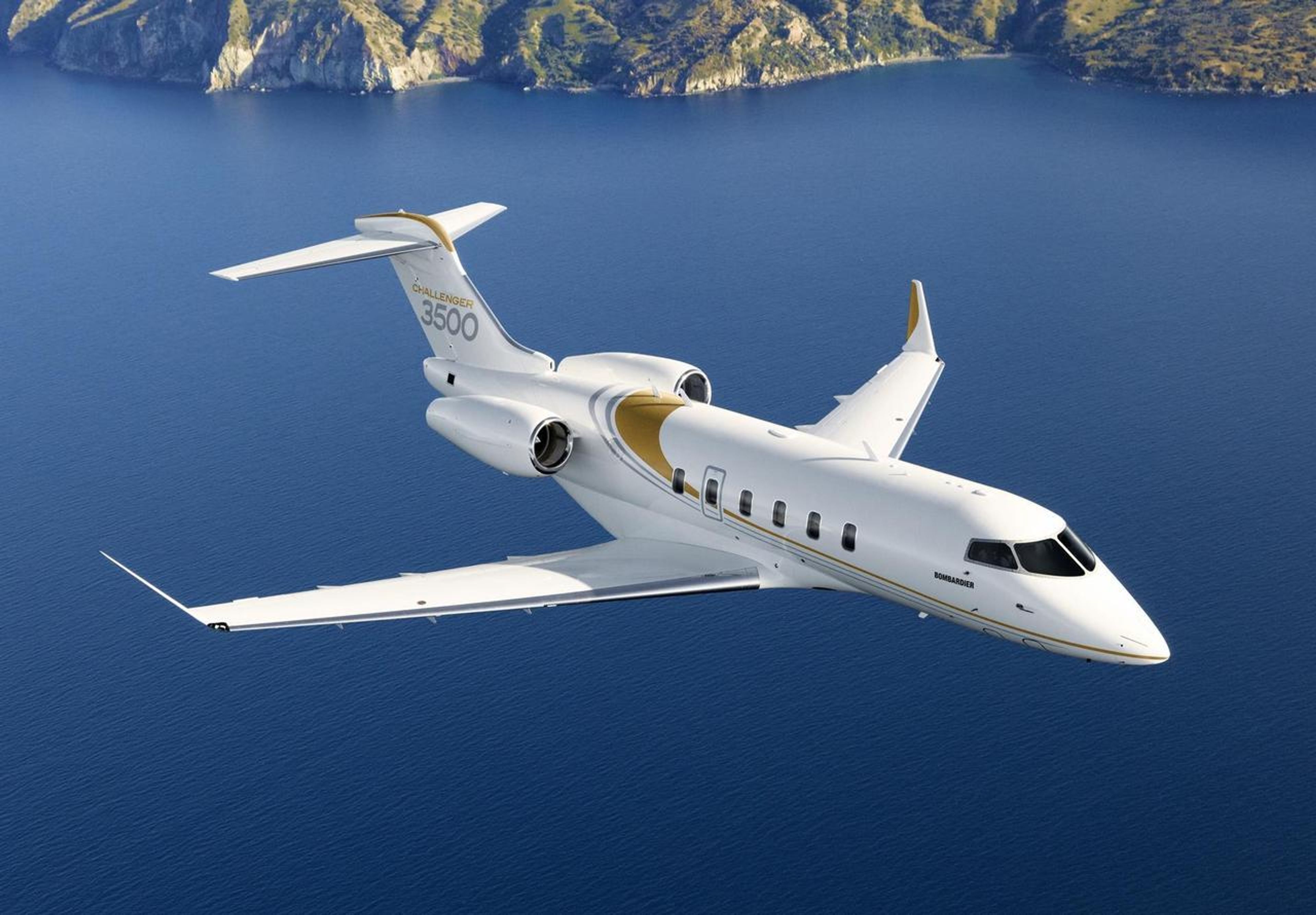 Bombardier challenger 3500 flying over water body