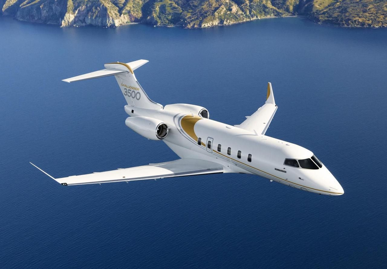 Bombardier challenger 3500 flying over water body
