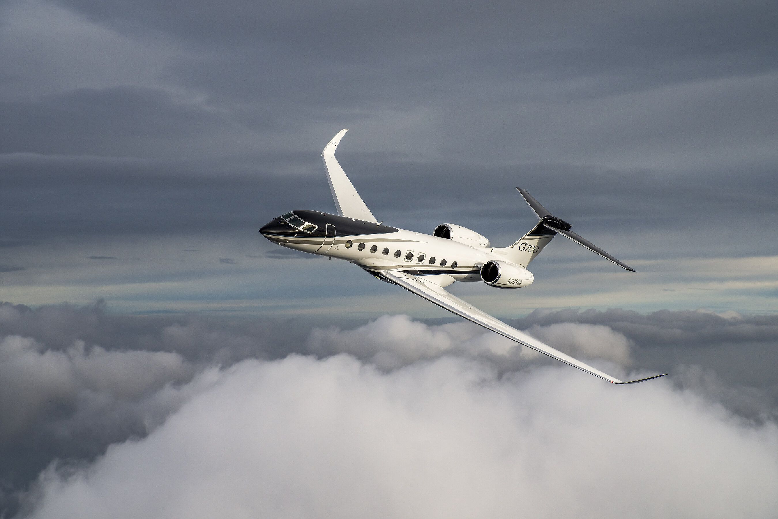 Gulfstream G700 banking above clouds