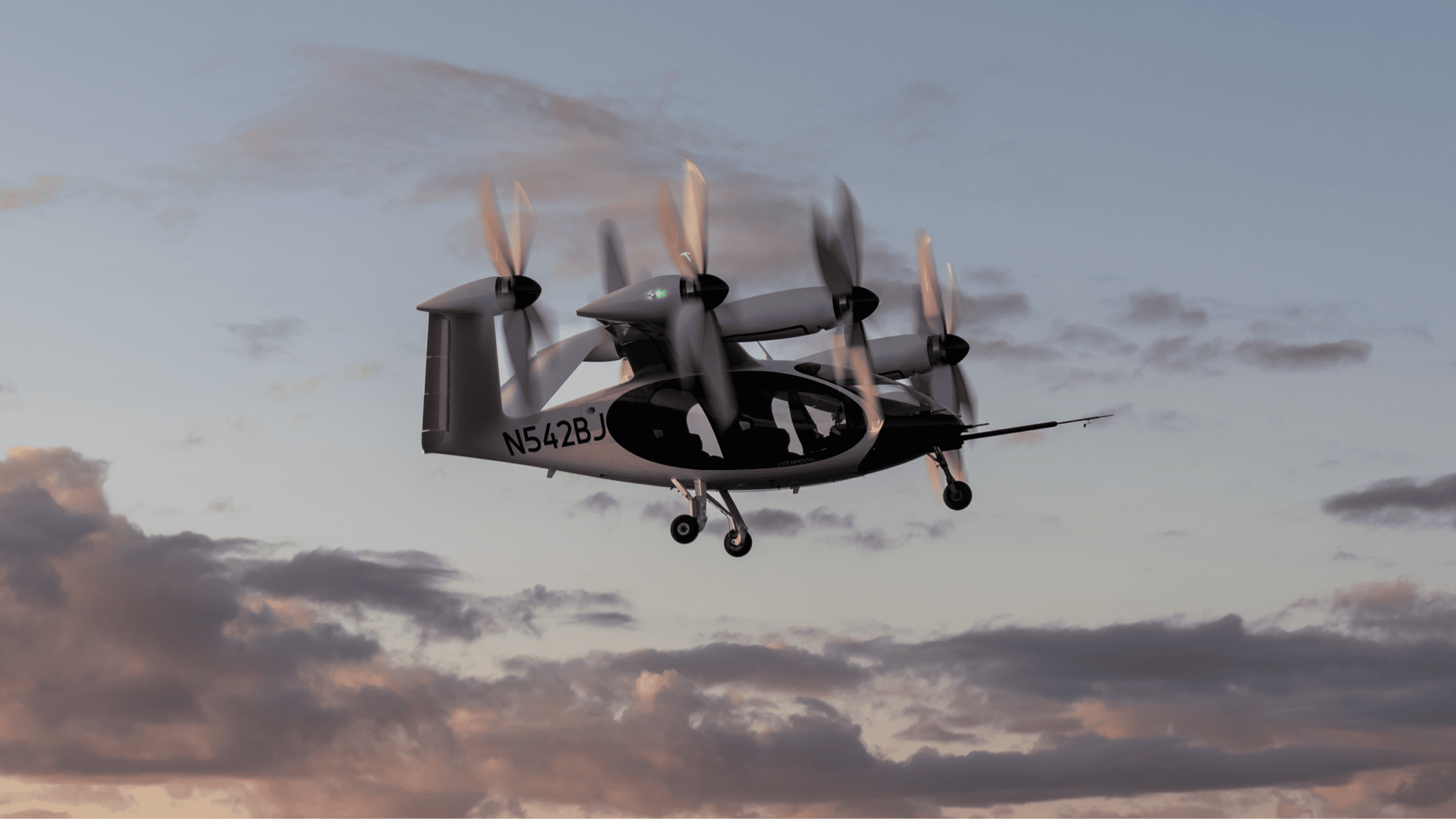 Joby electric vertical takeoff and landing aircraft in flight with its propellers in vertical-lift position