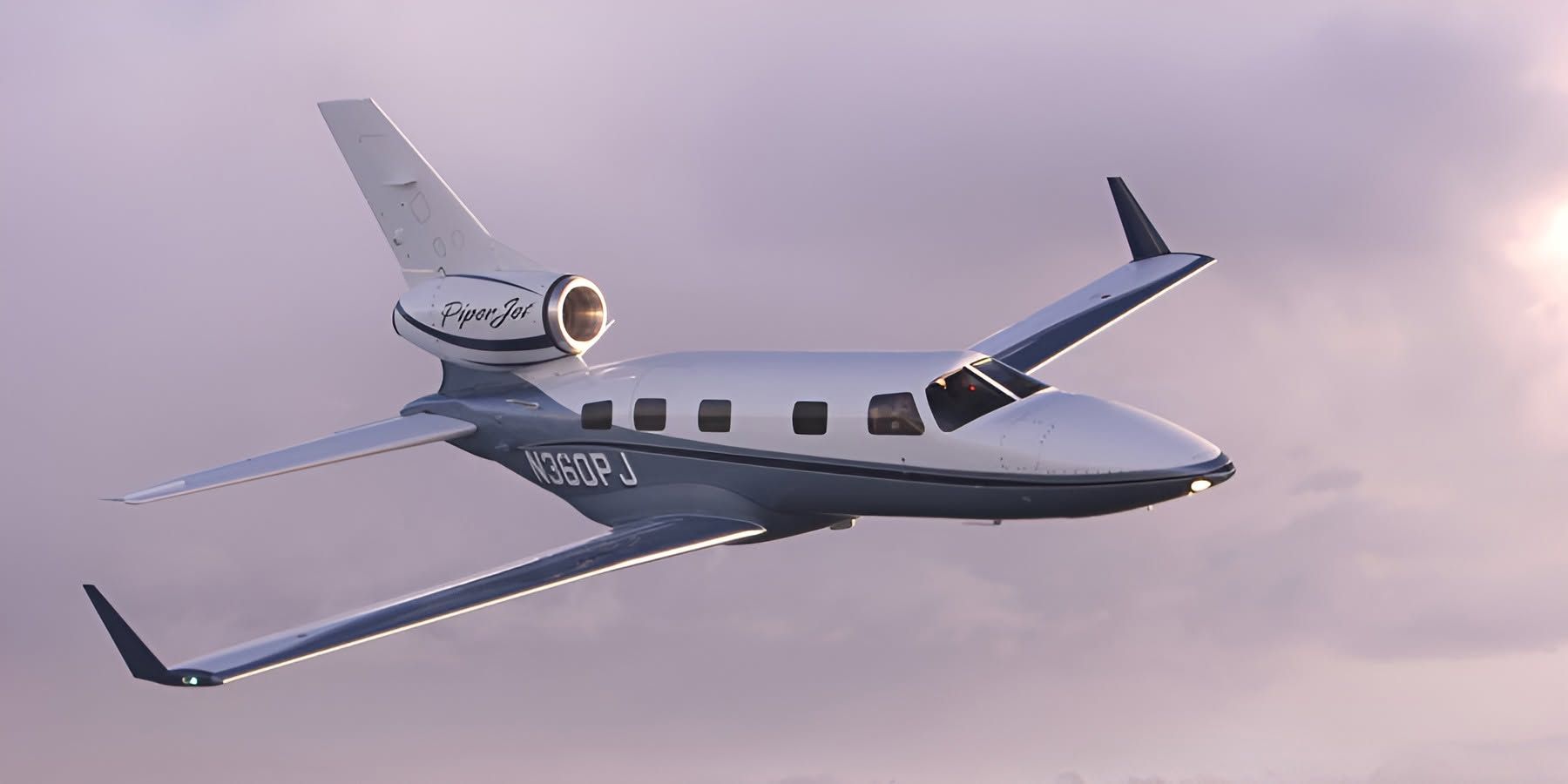 Piper PA-47 PiperJet prototype N360PJ in flight, showing its single tail-mounted engine against a purple sky.