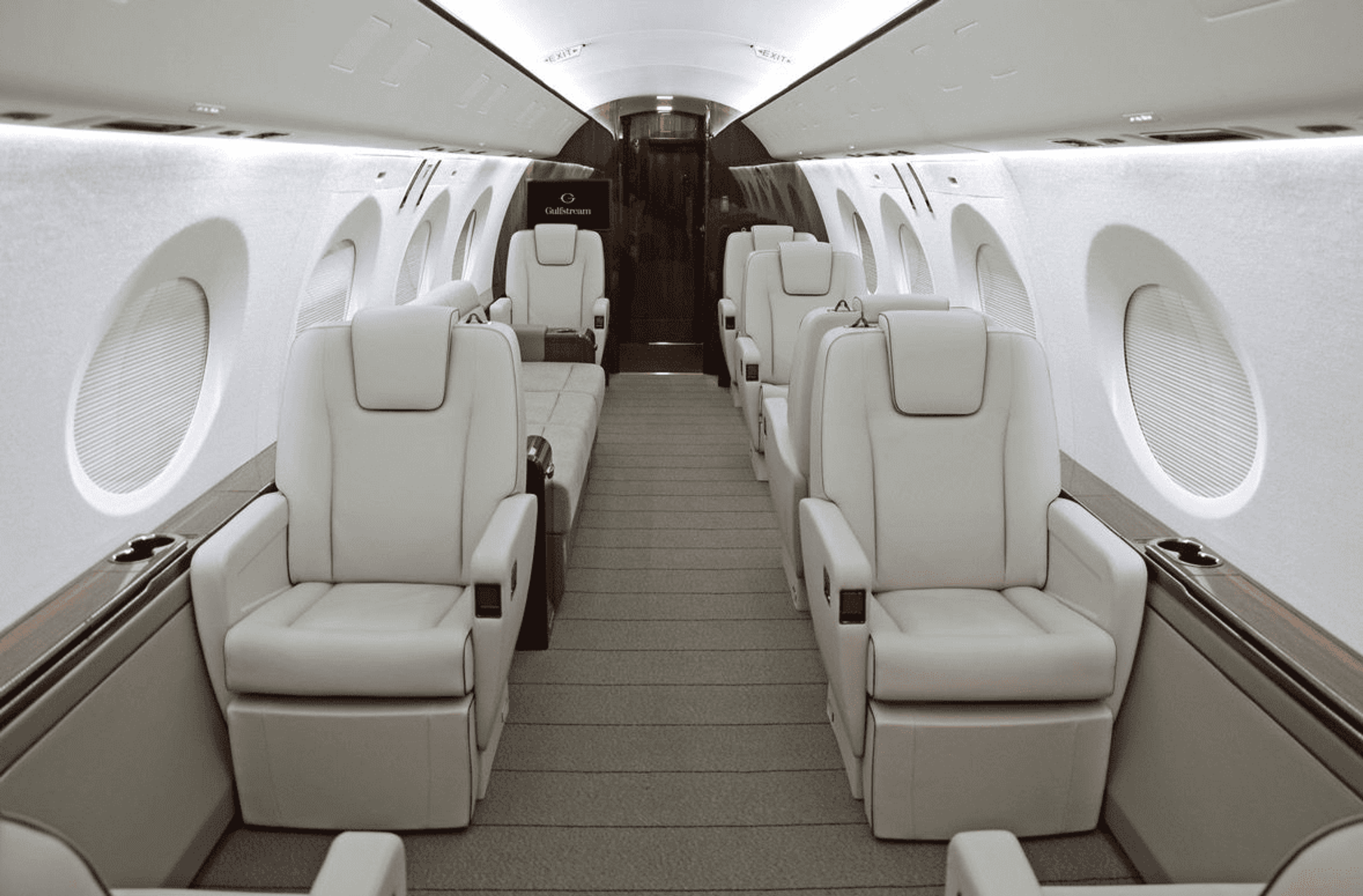 Gulfstream G400 cabin with cream leather seats, oval windows and a central aisle