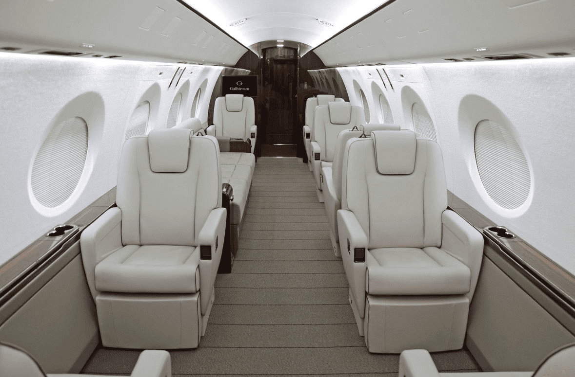 Gulfstream G400 cabin with cream leather seats, oval windows and a central aisle