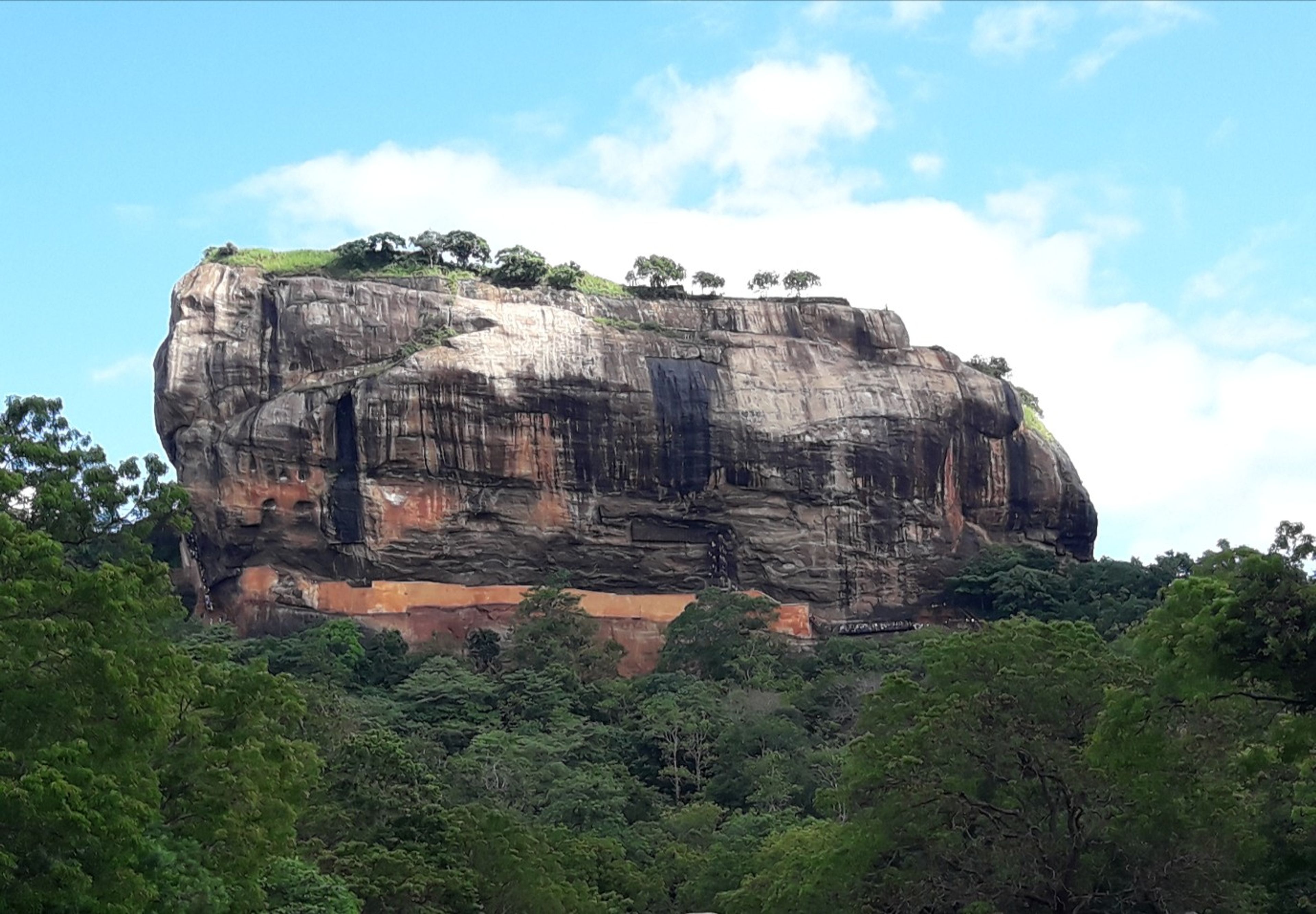 Sigiriya rock rising above the surrounding forest in Sri Lanka.
