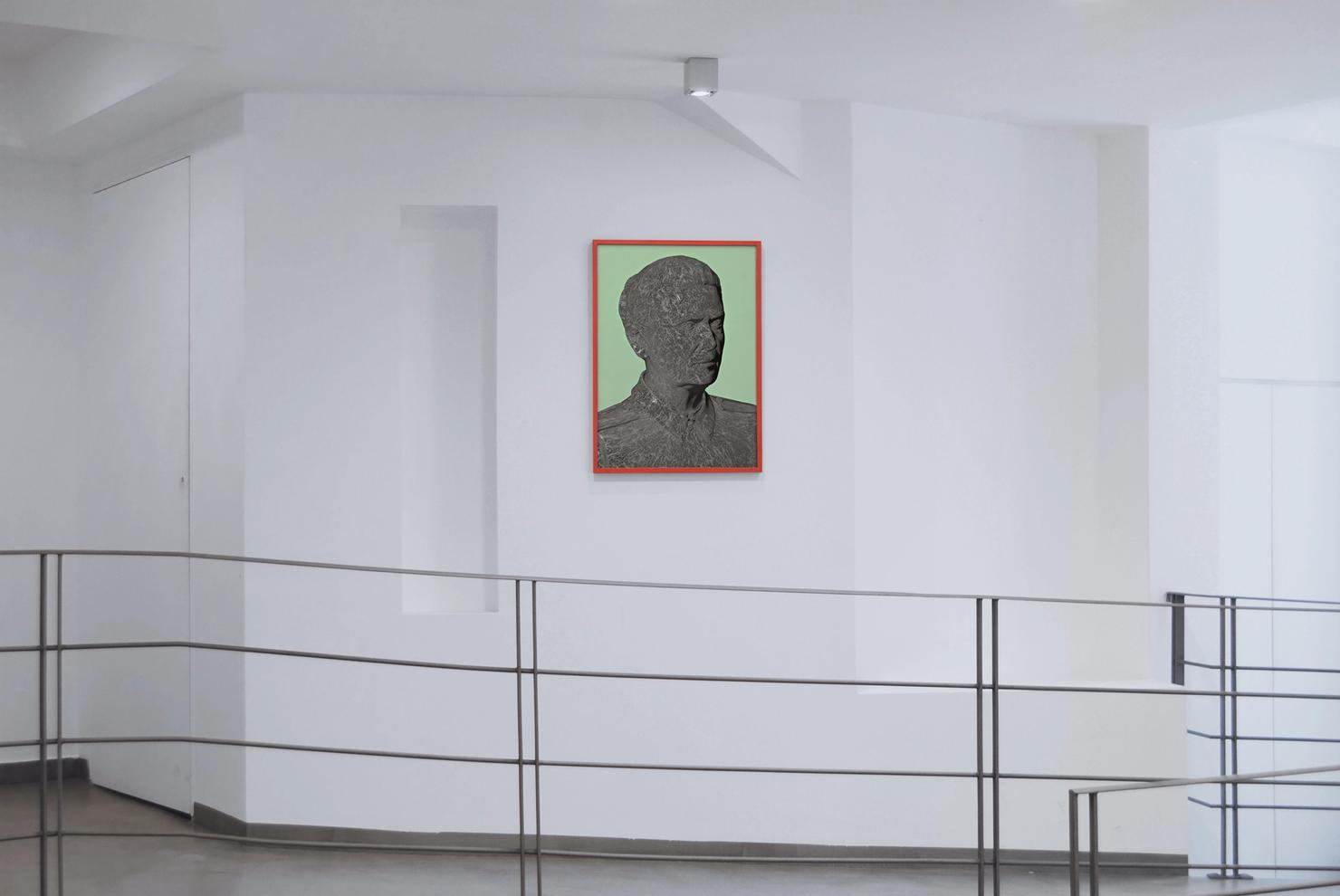 A dark grey cement ramp for the disabled in Art Space Pythagorion. On a white wall a very large, computer-generated portrait of Josip Broz Tito.