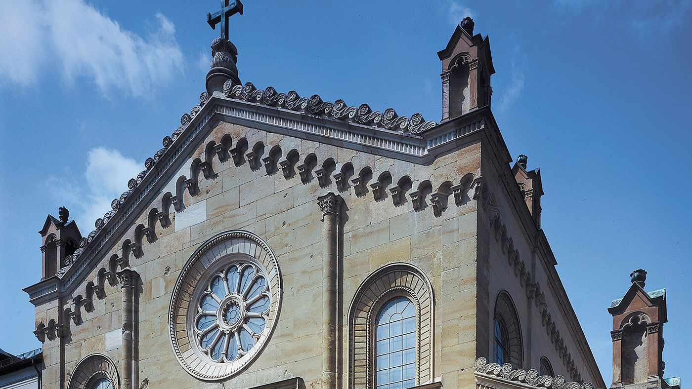 Image of the upper part of the fassade of the ancient church Allerheiligen-Hofkirche at the Residency of Munich in front of a blue sky