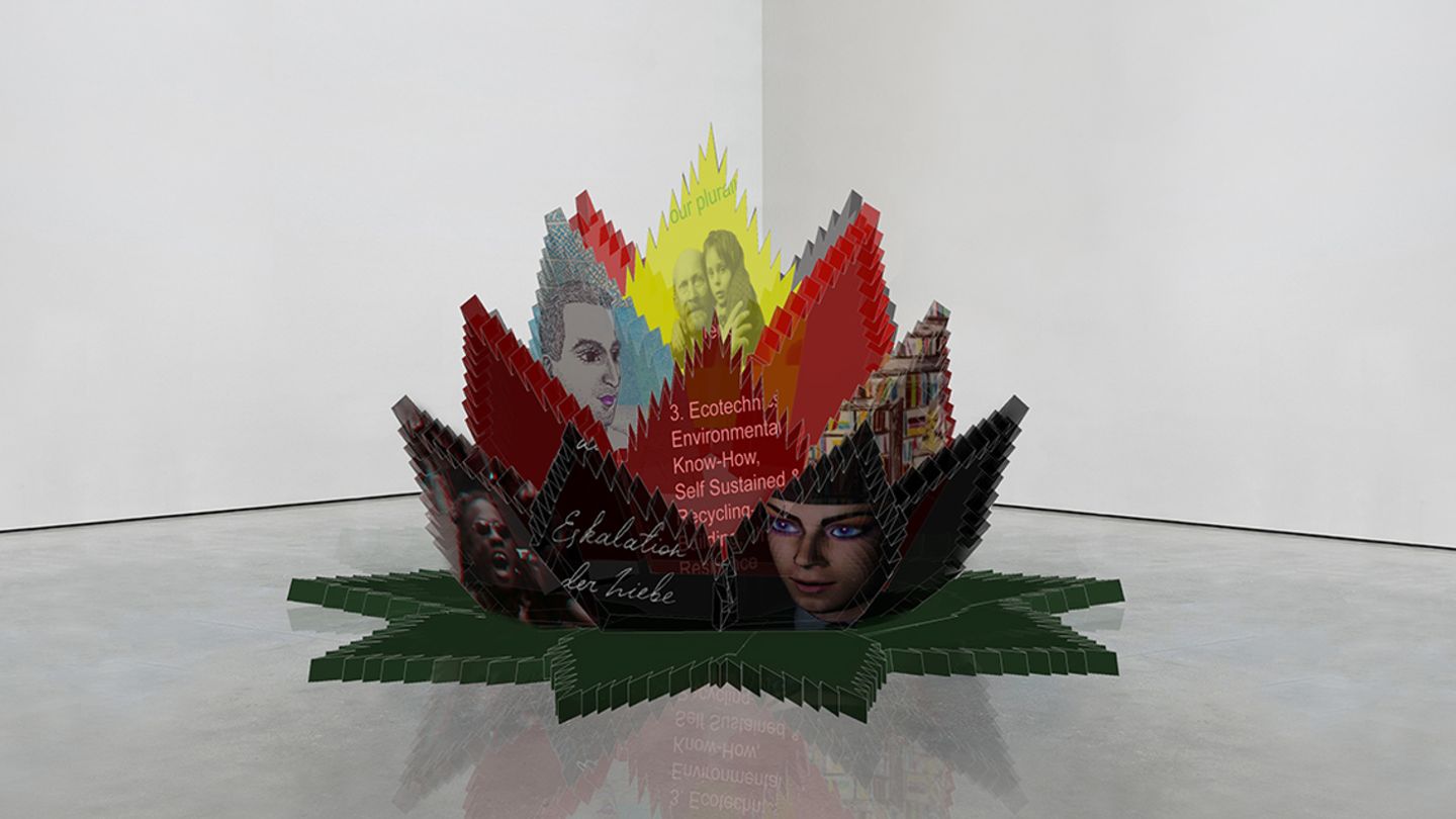 A digitally designed cacti plant-flower depicting images and text as leaves and placed in the corner of a white-wall room with cement floors.