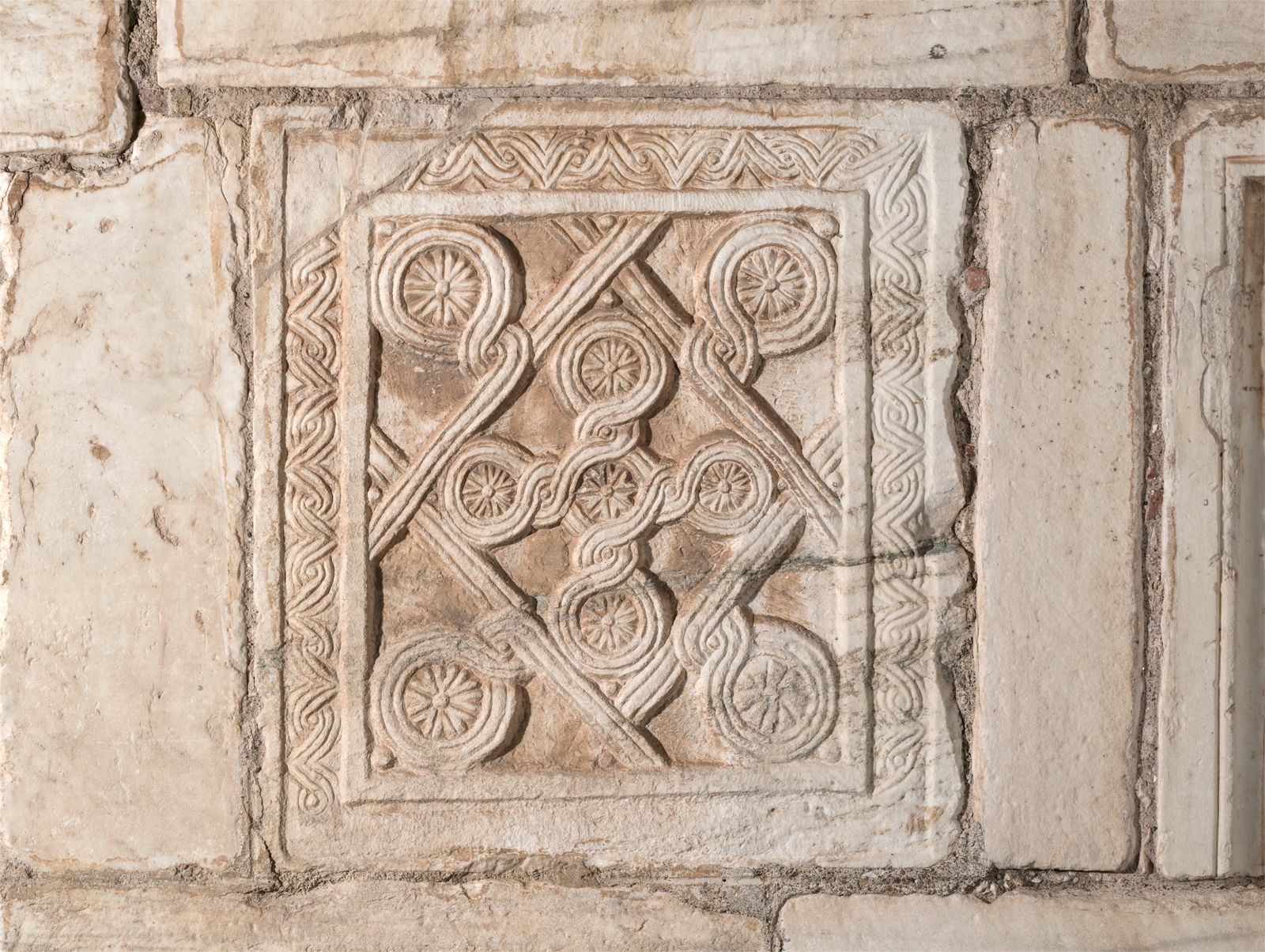 Byzantine closure slab relief with a banded lozenge flanked by four large rosettes and a banded cross with five smallrosettes in the middle, Little Metropolis of Athens.