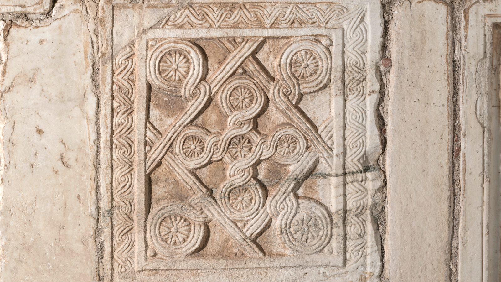 Byzantine closure slab relief with a banded lozenge flanked by four large rosettes and a banded cross with five smallrosettes in the middle, Little Metropolis of Athens.