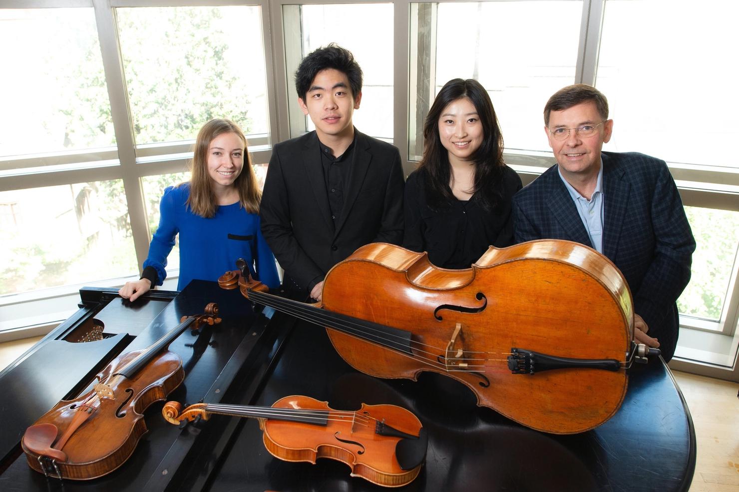 Claire Bourg, Daniel Hsu, Sydney Lee and Roberto Diaz posing behind their instruments (piano, violin, cello, viola)
