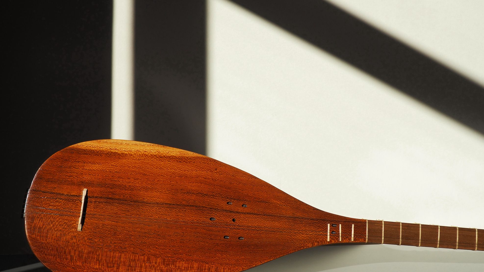 Close up of a traditonal string music instrument that looks like an oud. It is pictured string-less