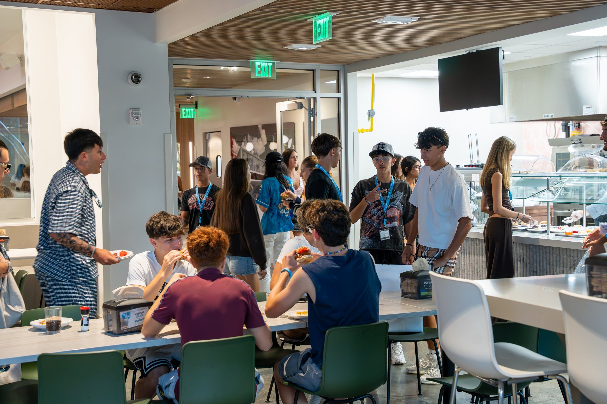 Students at the dining-hall food counter and tables