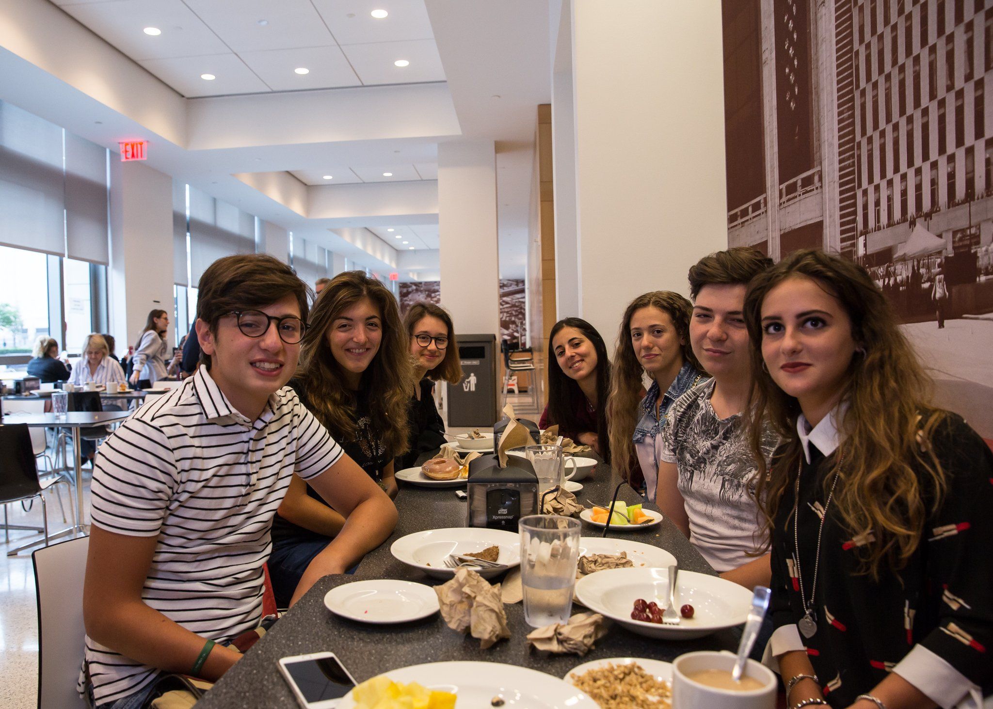 A group of YES USA students smiling around a breakfast table