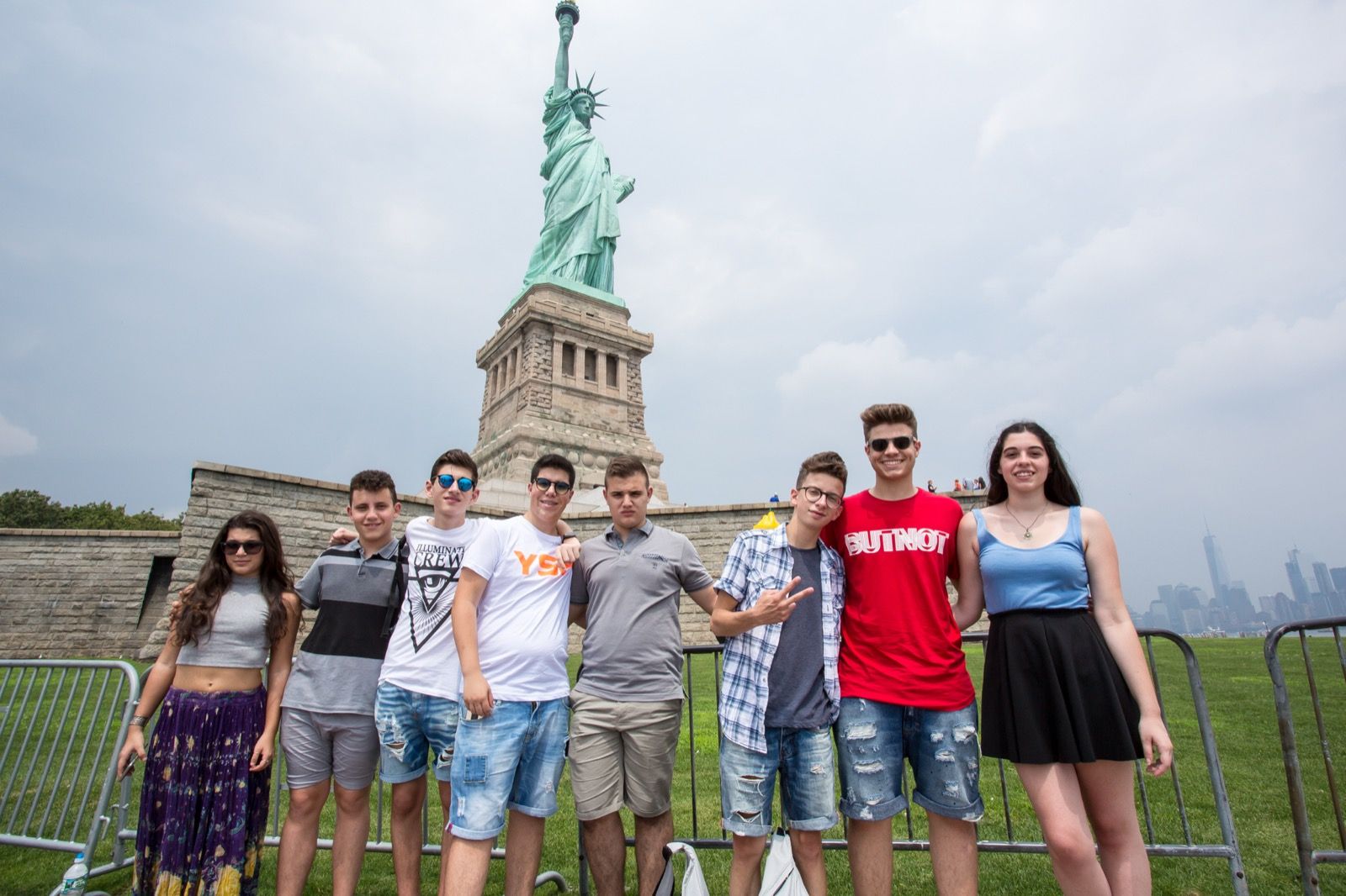 Students posing in front of the Statue of Liberty on Liberty Island