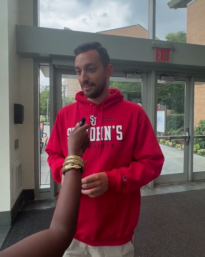 Giuseppe, a group leader, speaking on camera on campus