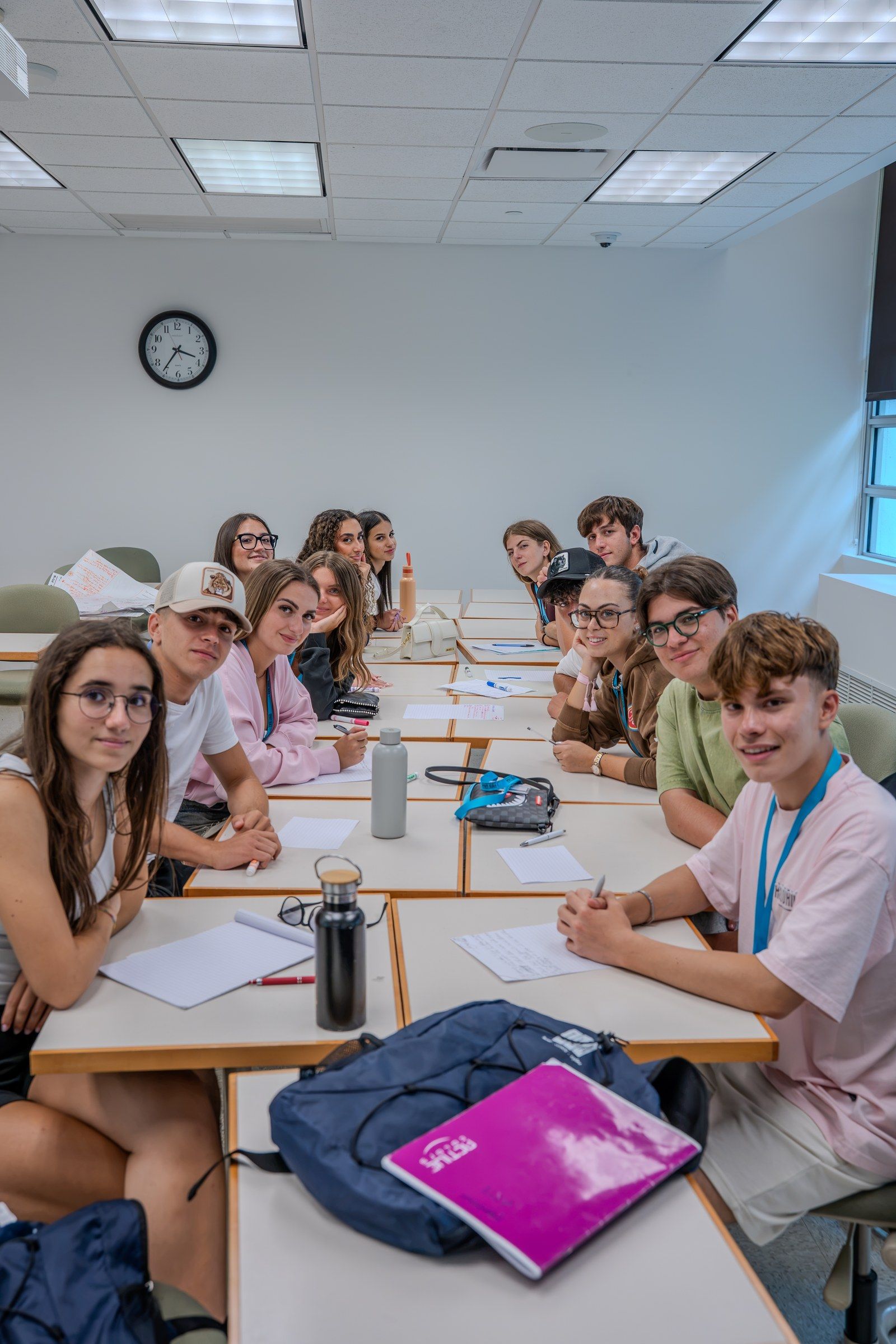Smiling students around the tables in a YES USA classroom