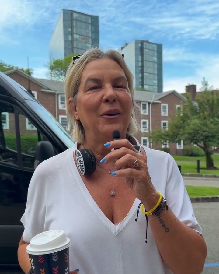Lyna, a group leader, speaking on camera on campus