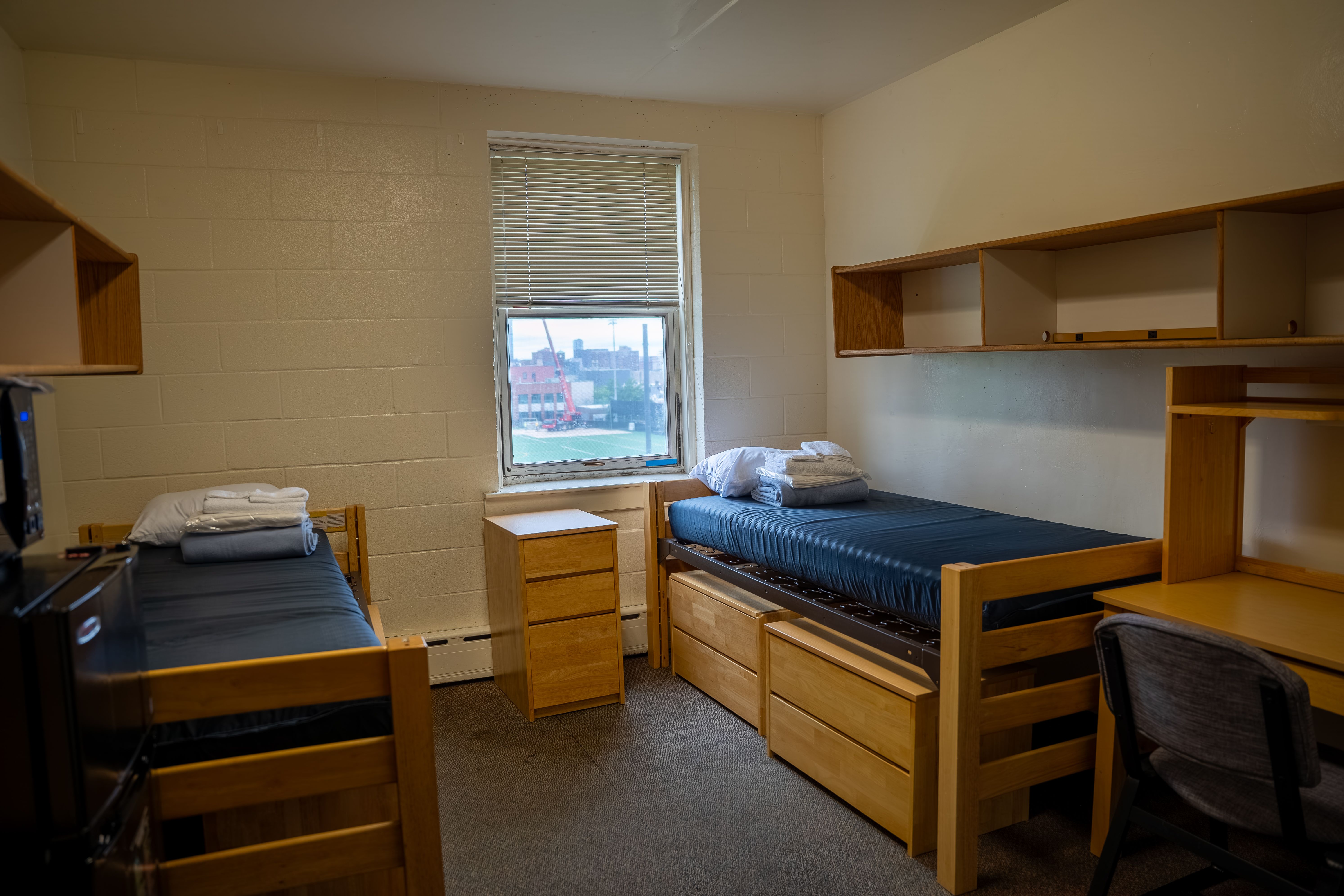 Twin beds, desks and storage in a Jonas Hall room at Stevens