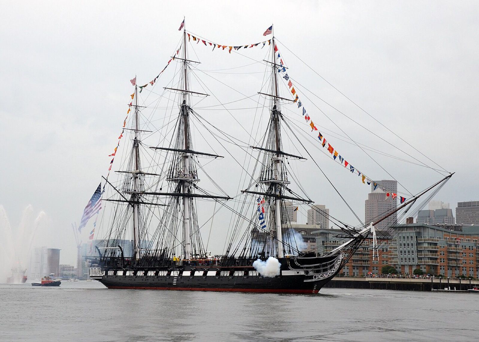 USS Constitution firing a ceremonial salute in Boston Harbor