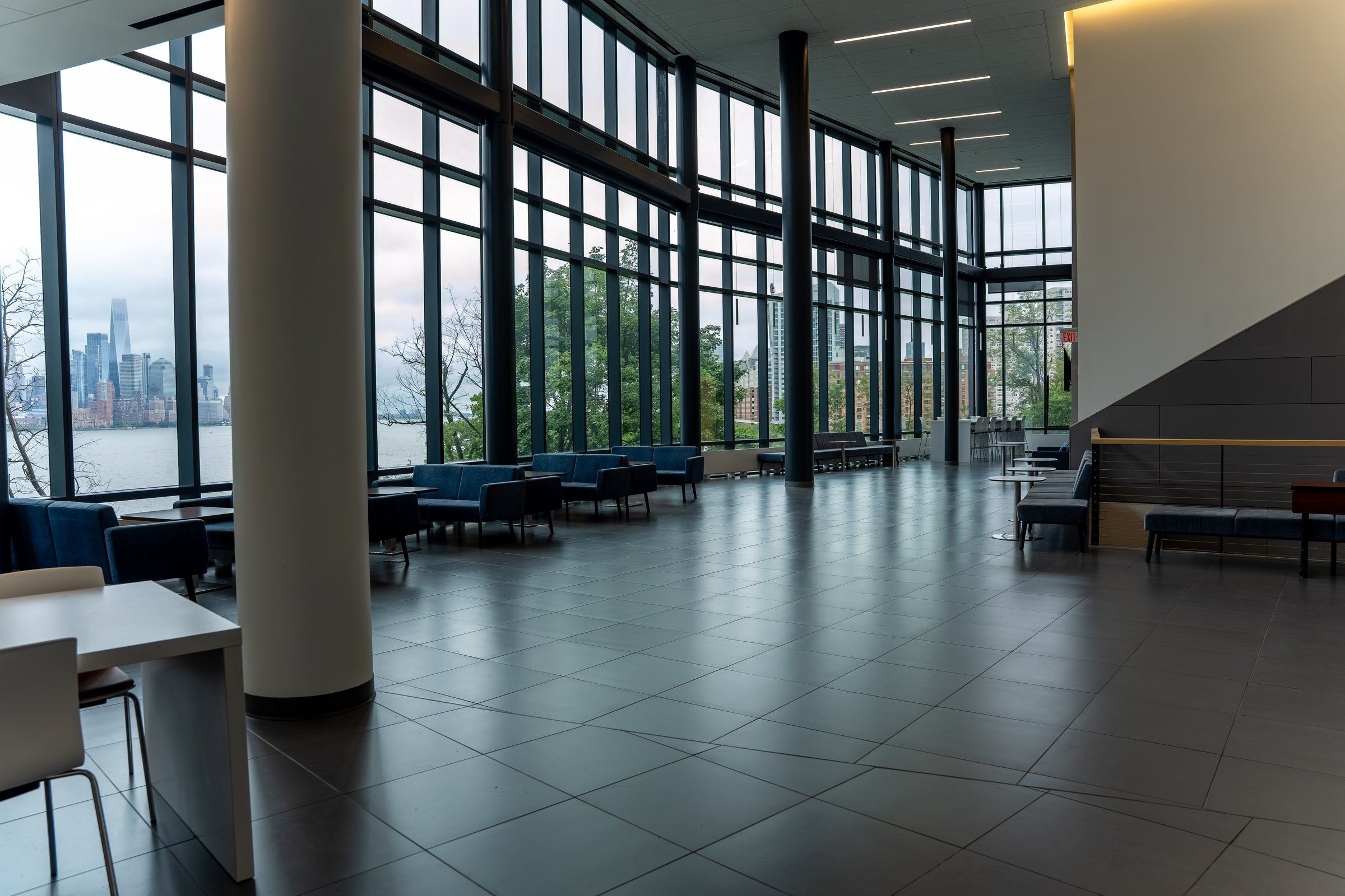Glass atrium with seating and views of the Manhattan skyline at Stevens