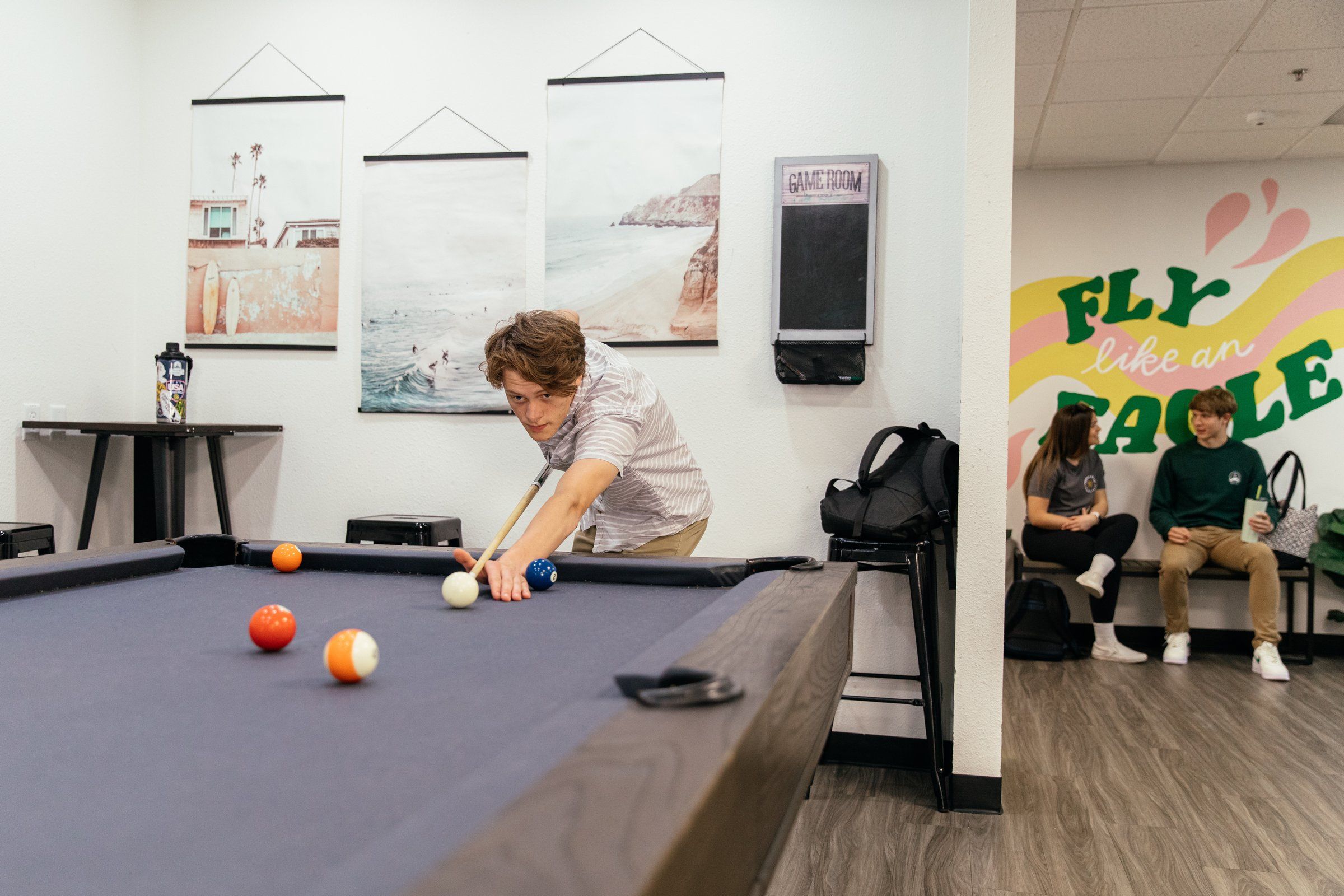 Game room with a pool table in the Chi Sigma residence lounge at Concordia