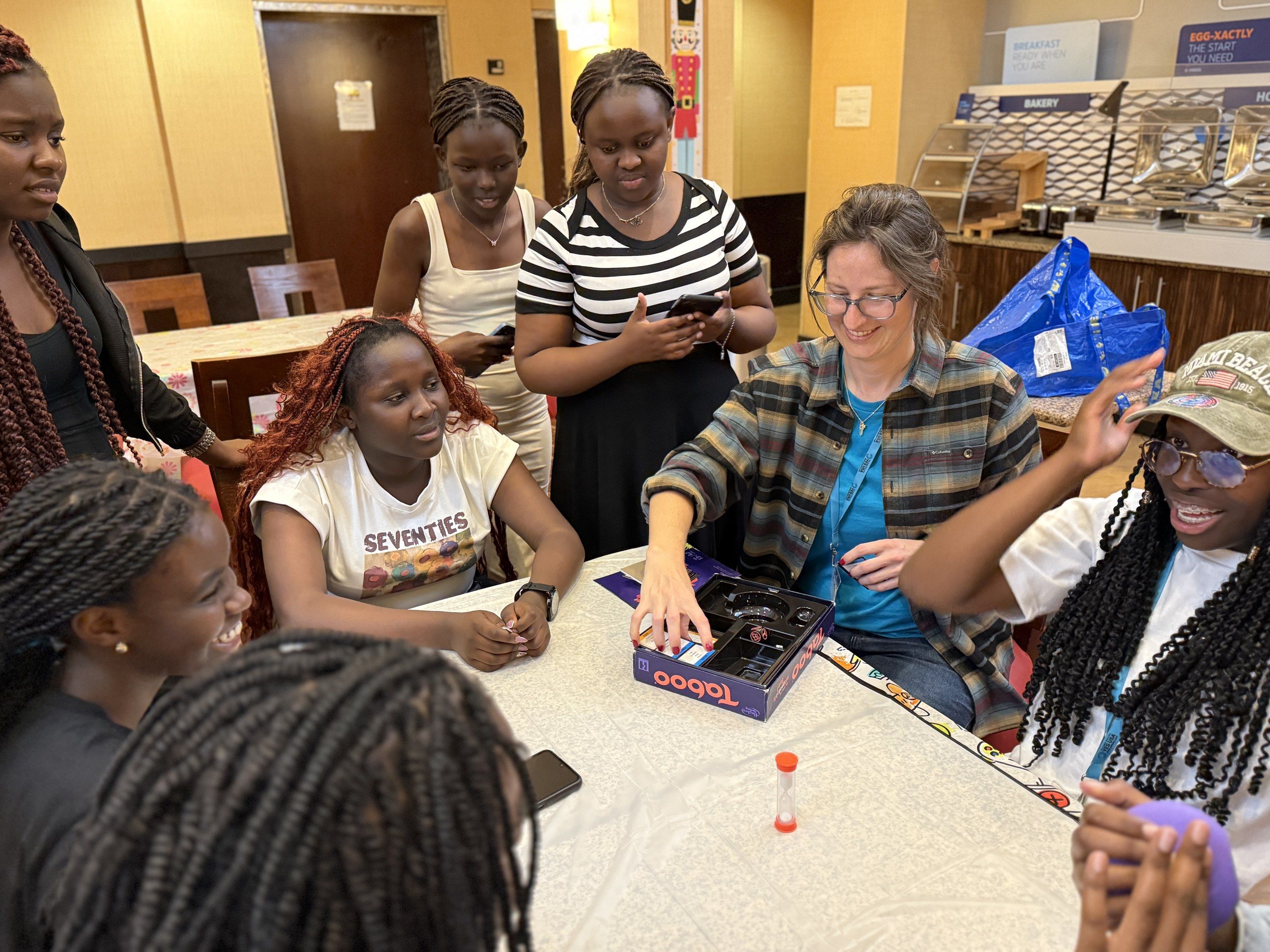 Students and a YES USA staff member at a table at the hotel in Kendall