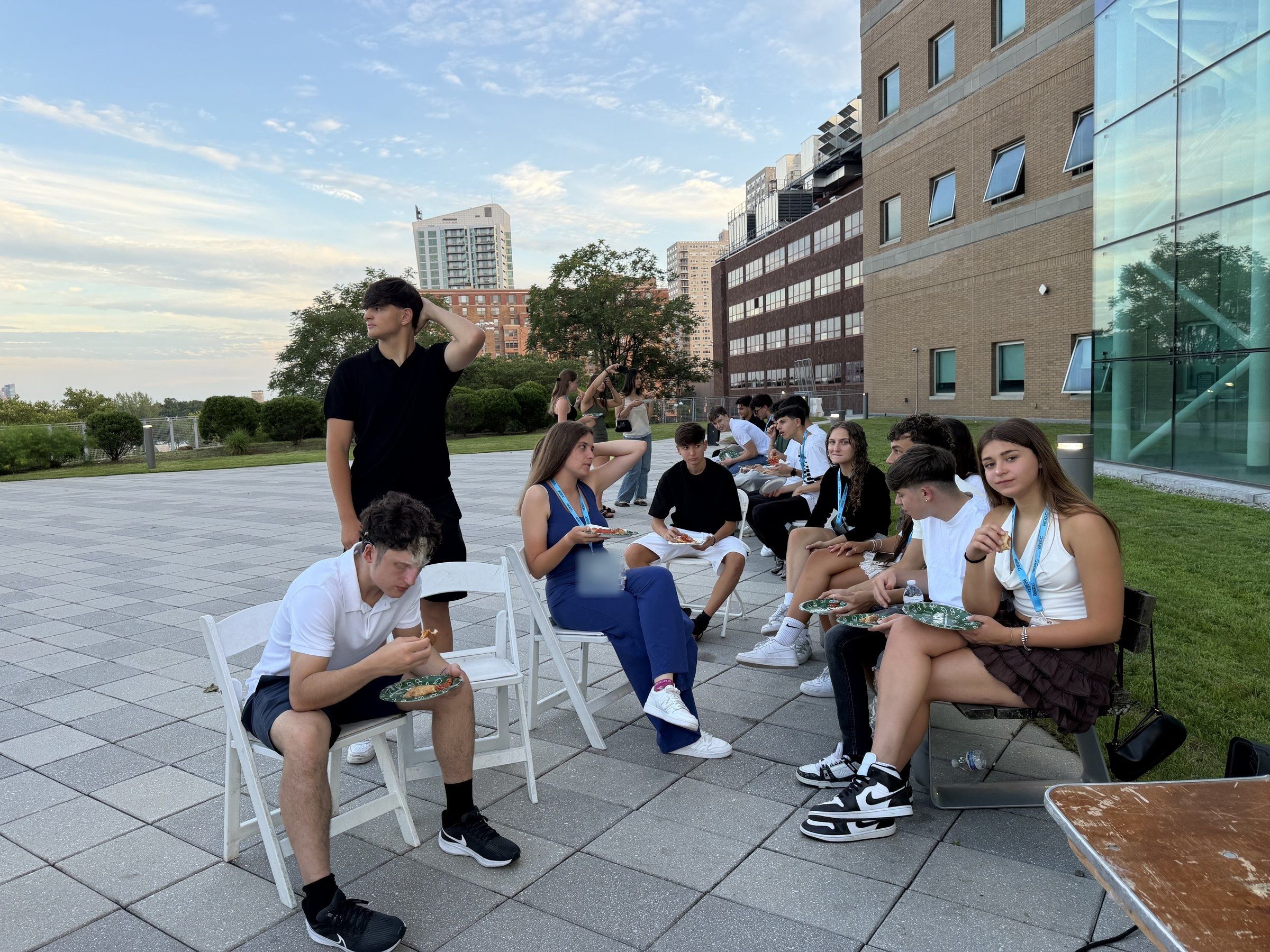 Students hanging out on a campus terrace in the evening at Stevens