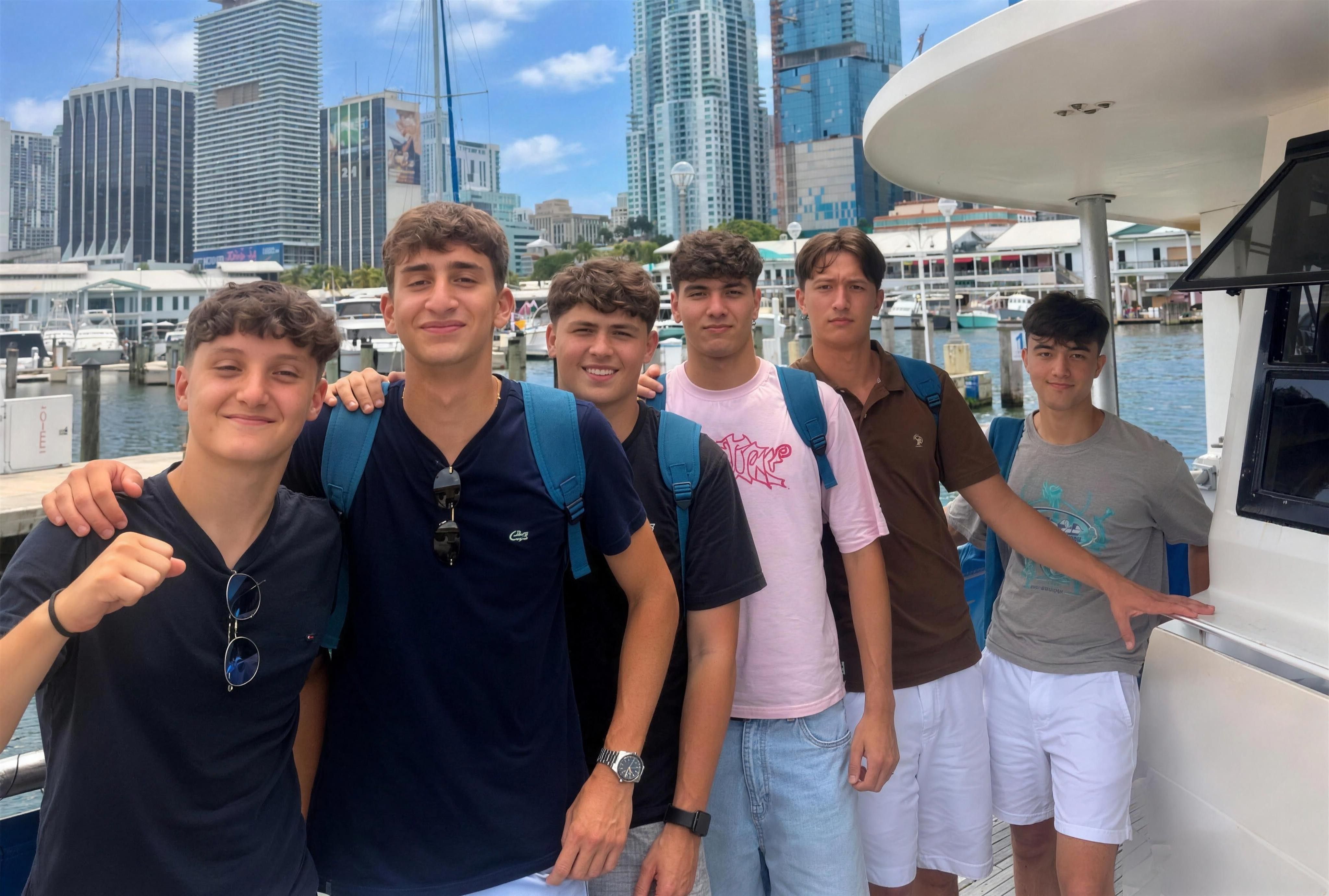 YES USA students smiling on a boat tour with the Miami skyline behind them