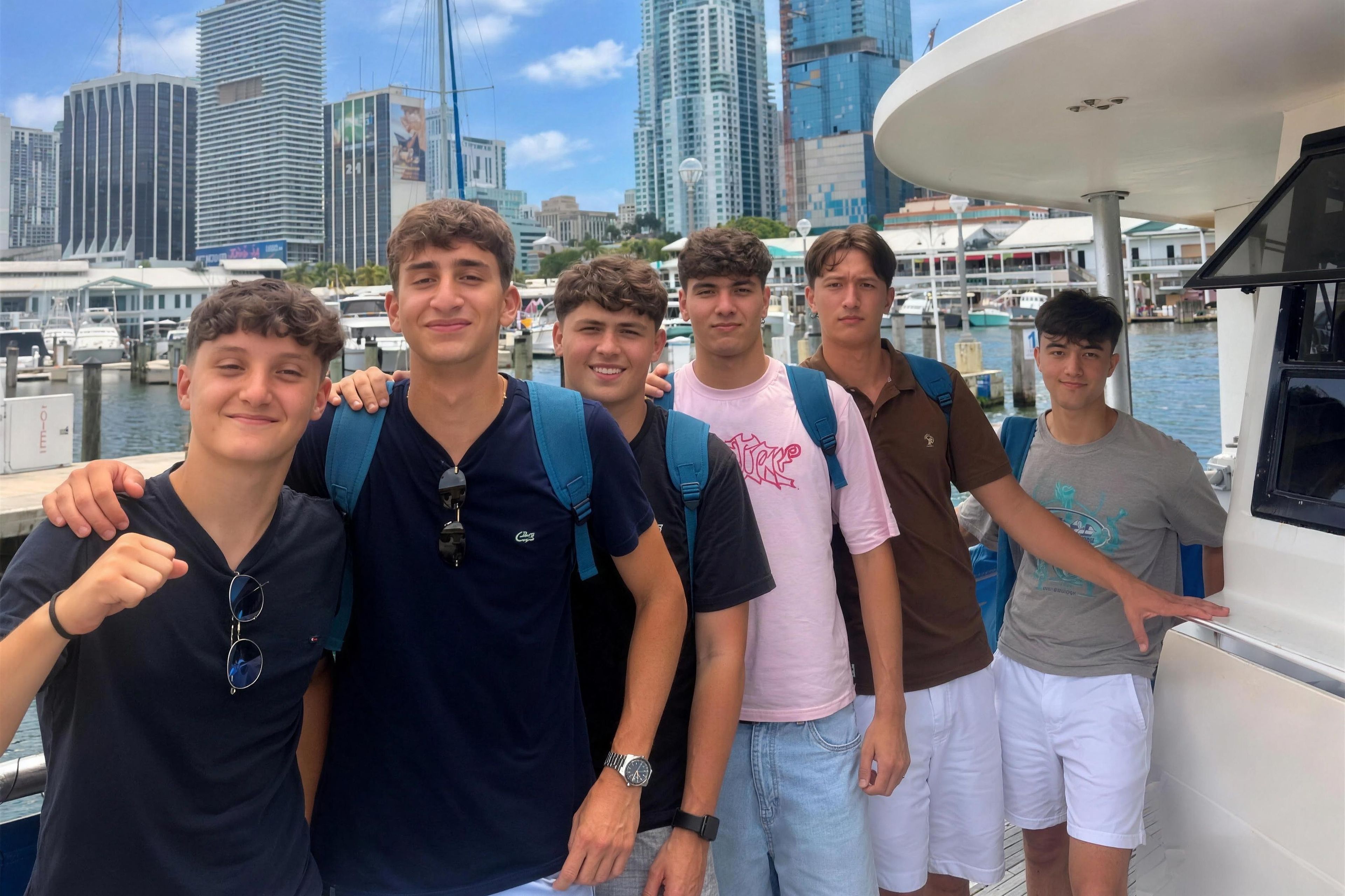 YES USA students smiling on a boat tour with the Miami skyline behind them