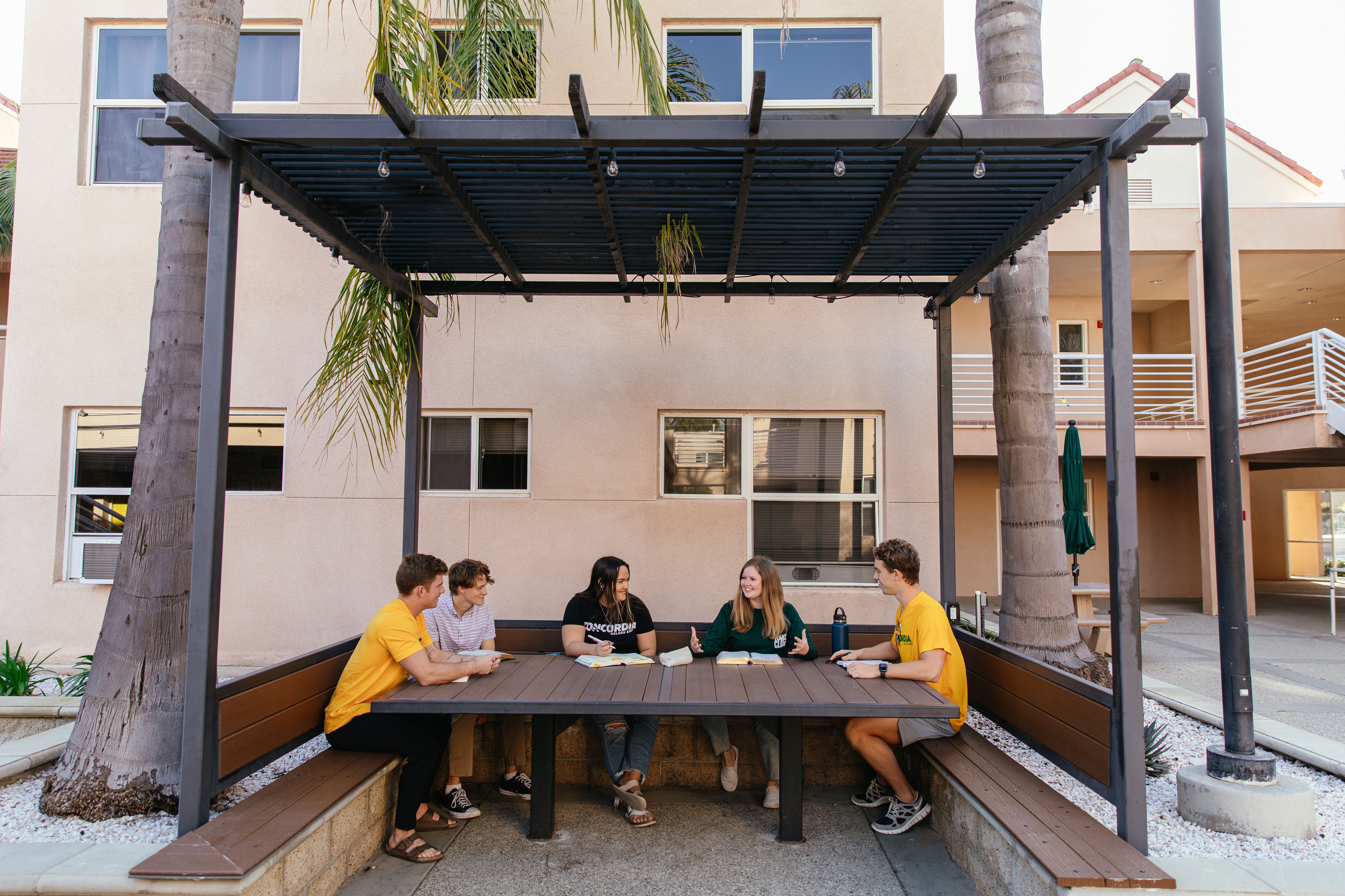 Students sitting in the outdoor common area at Concordia Irvine