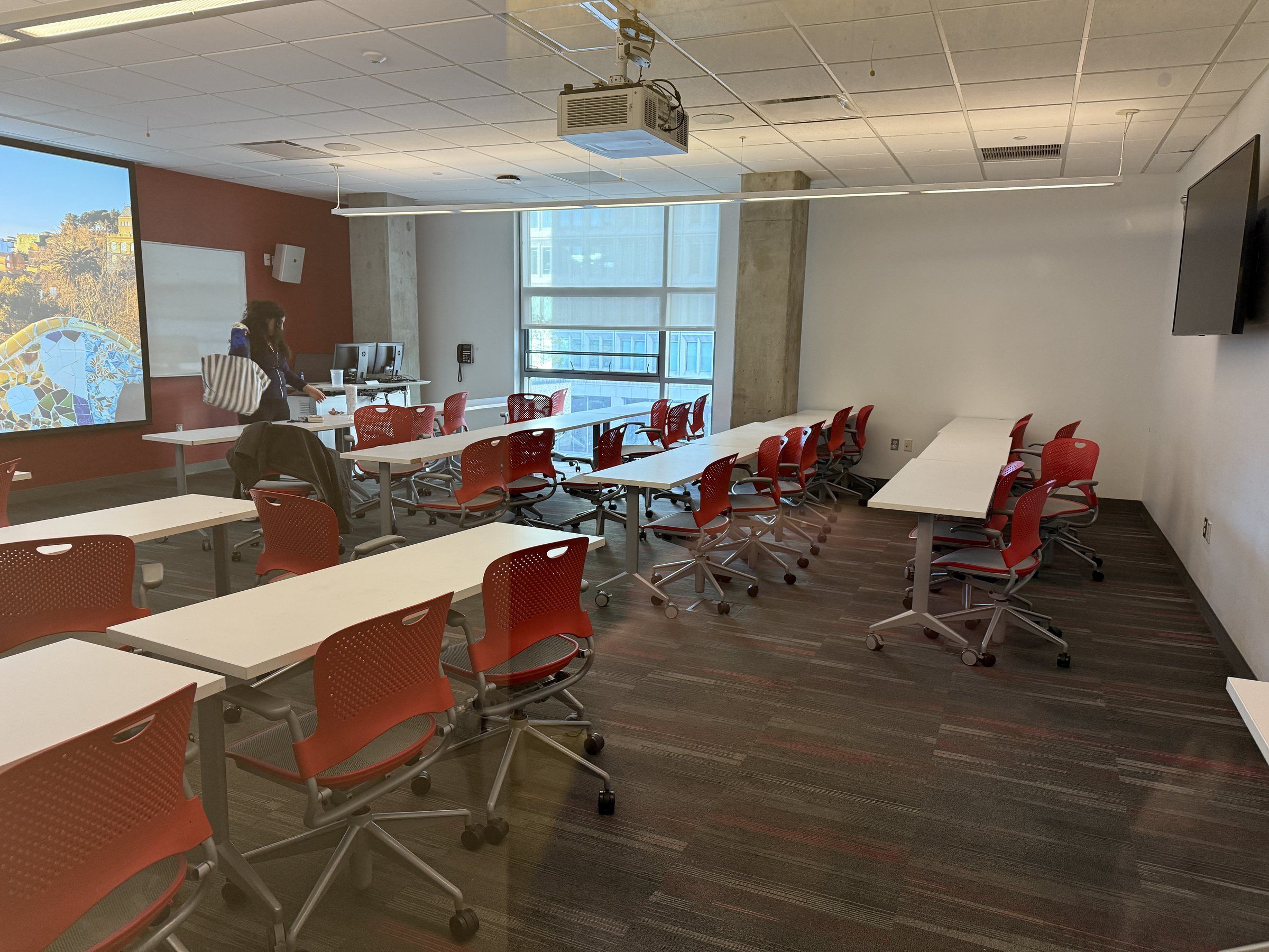 Classroom with red chairs and large windows at Suffolk University