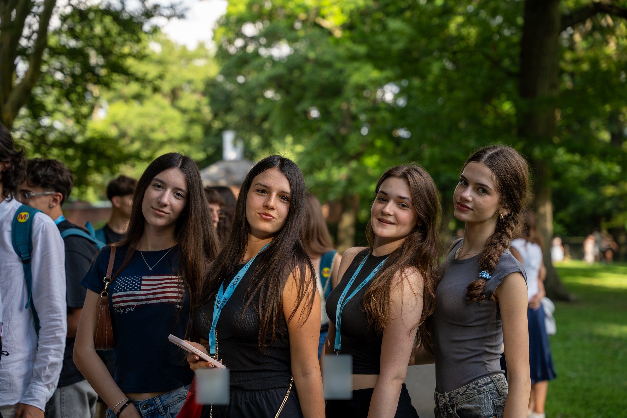 Four YES USA students posing together in a leafy park