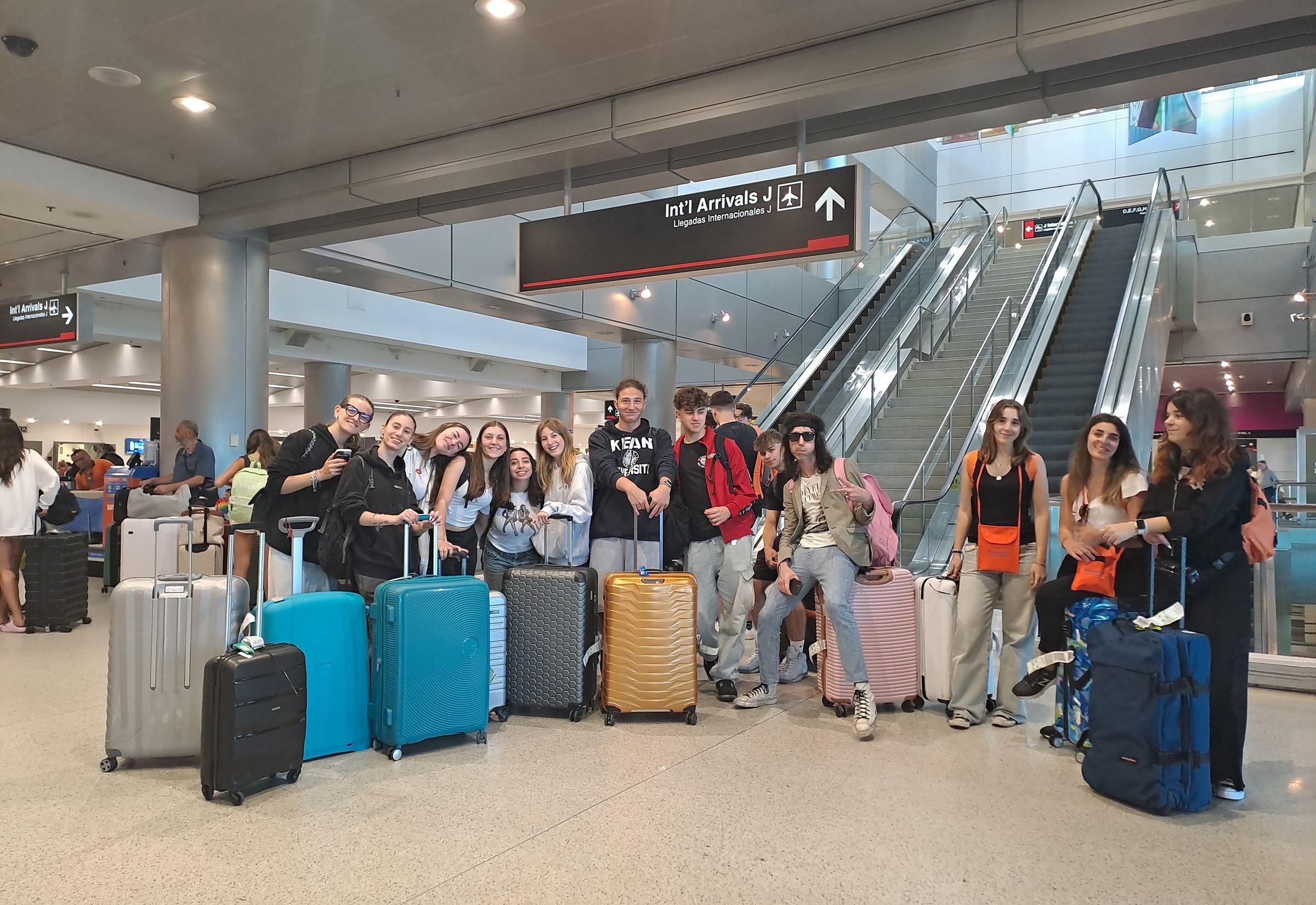 A YES USA group with their suitcases in an airport arrivals hall