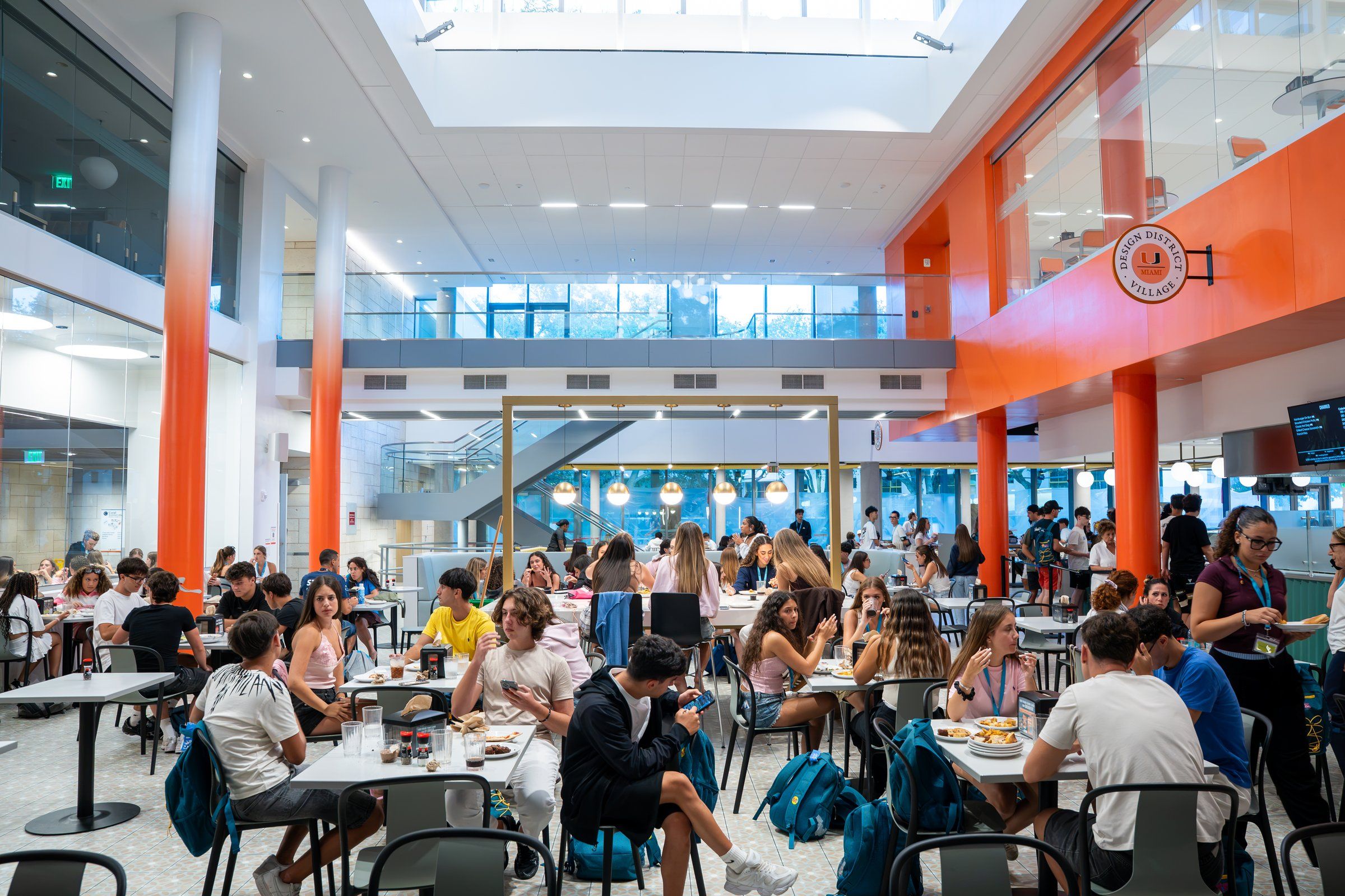 A bright two-storey campus dining hall full of YES USA students at lunch