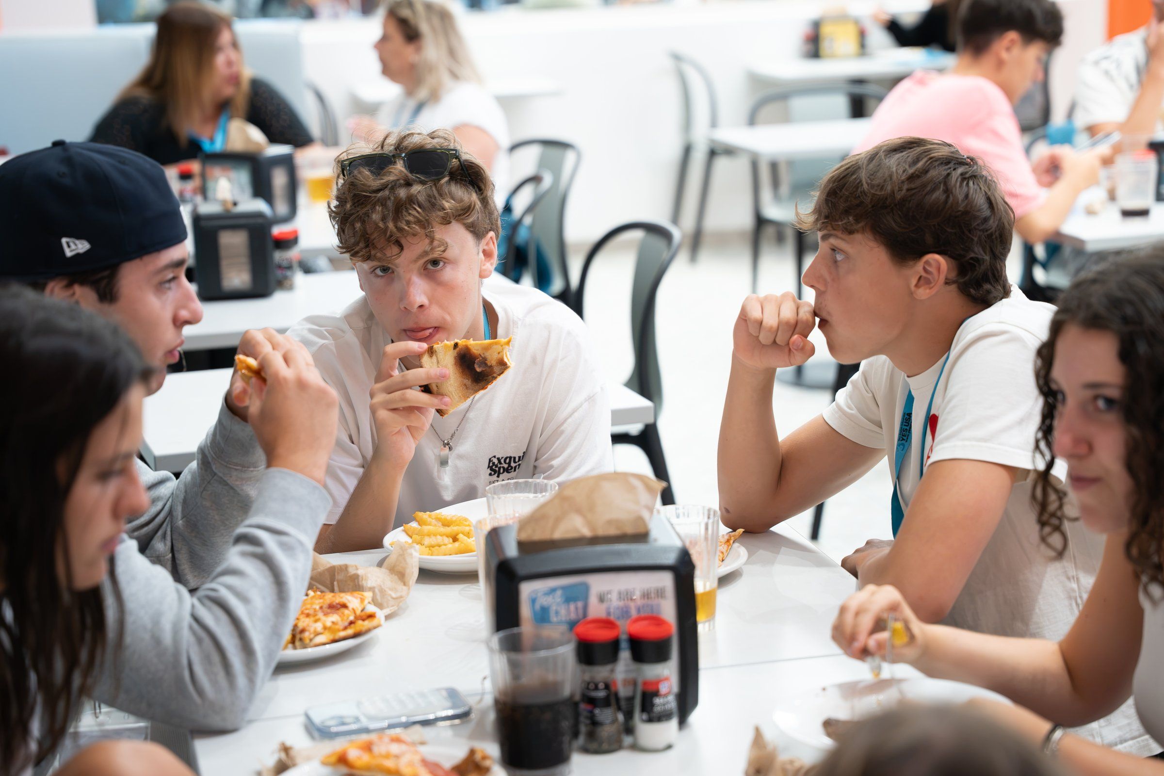 YES USA students sharing pizza and fries in the campus dining hall