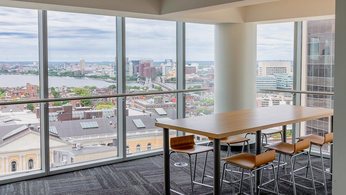 Study area with a high table and stools overlooking the Charles River in Miller Hall