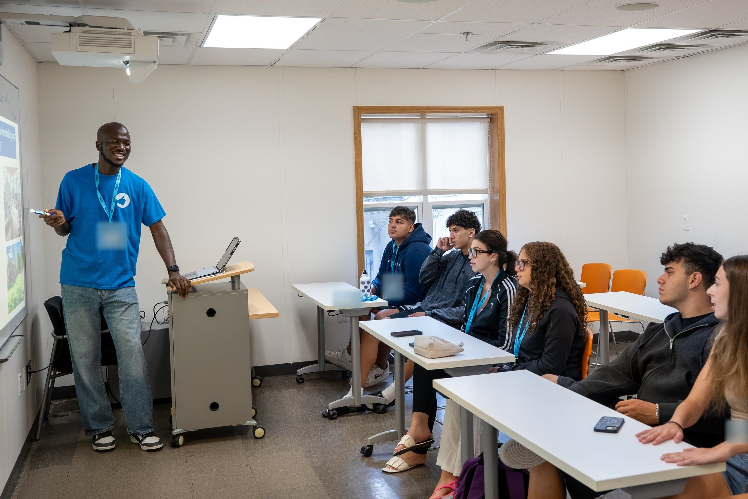 A YES USA teacher leads an English lesson while students listen at their desks, at Stevens Institute of Technology
