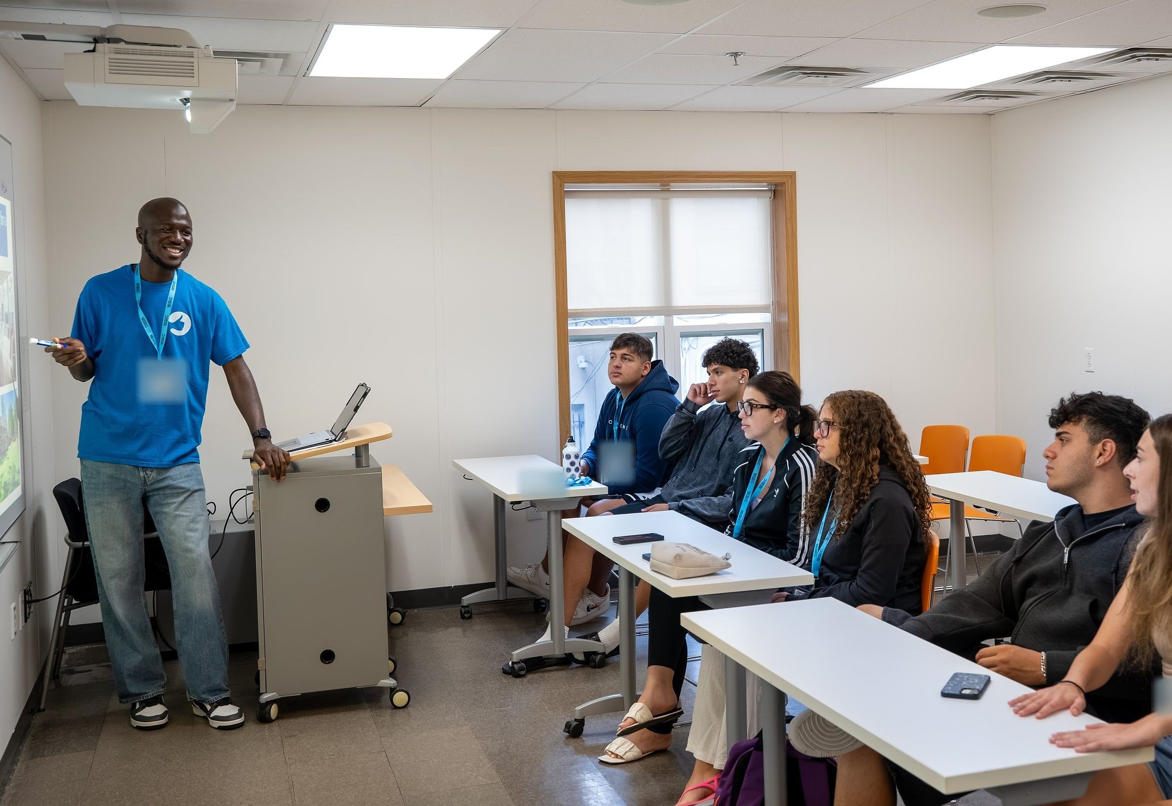 A YES USA teacher leads an English lesson while students listen at their desks, at Stevens Institute of Technology