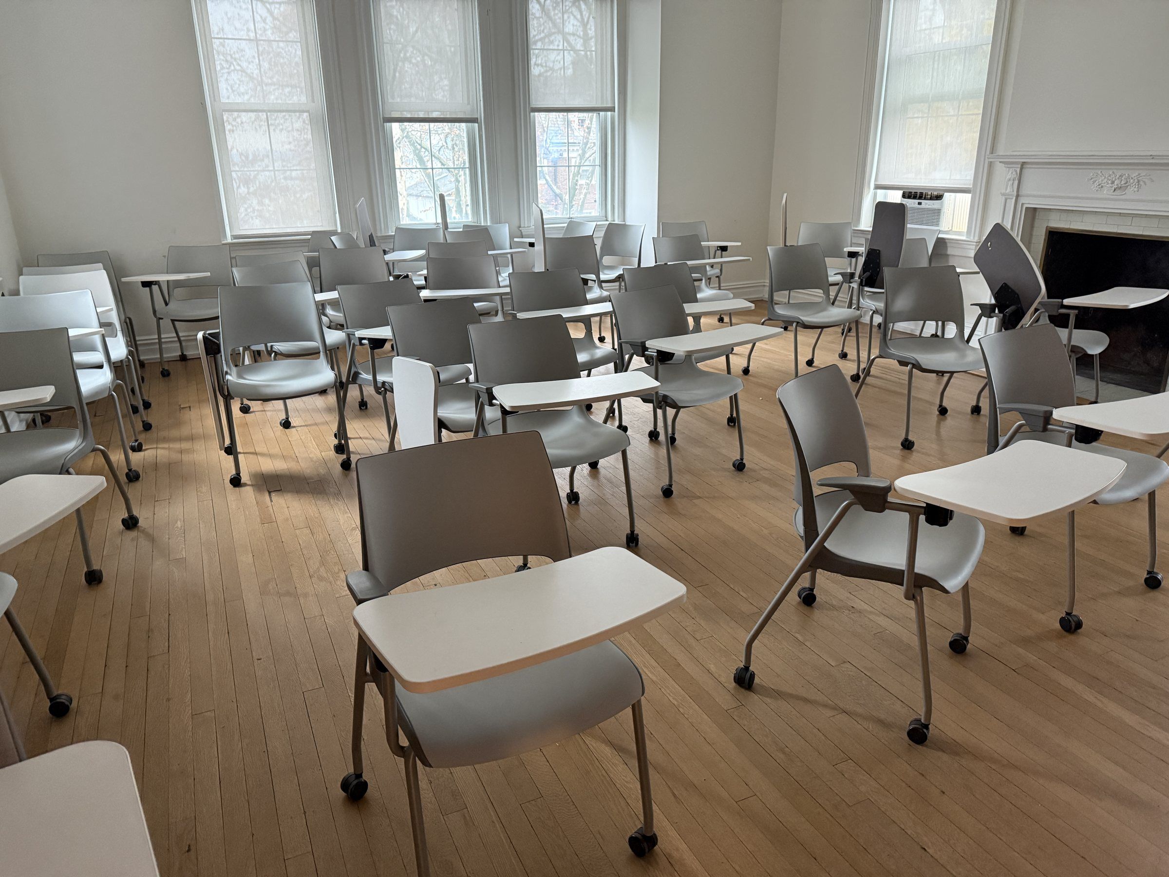Classroom with tablet-arm chairs and tall windows at Stevens