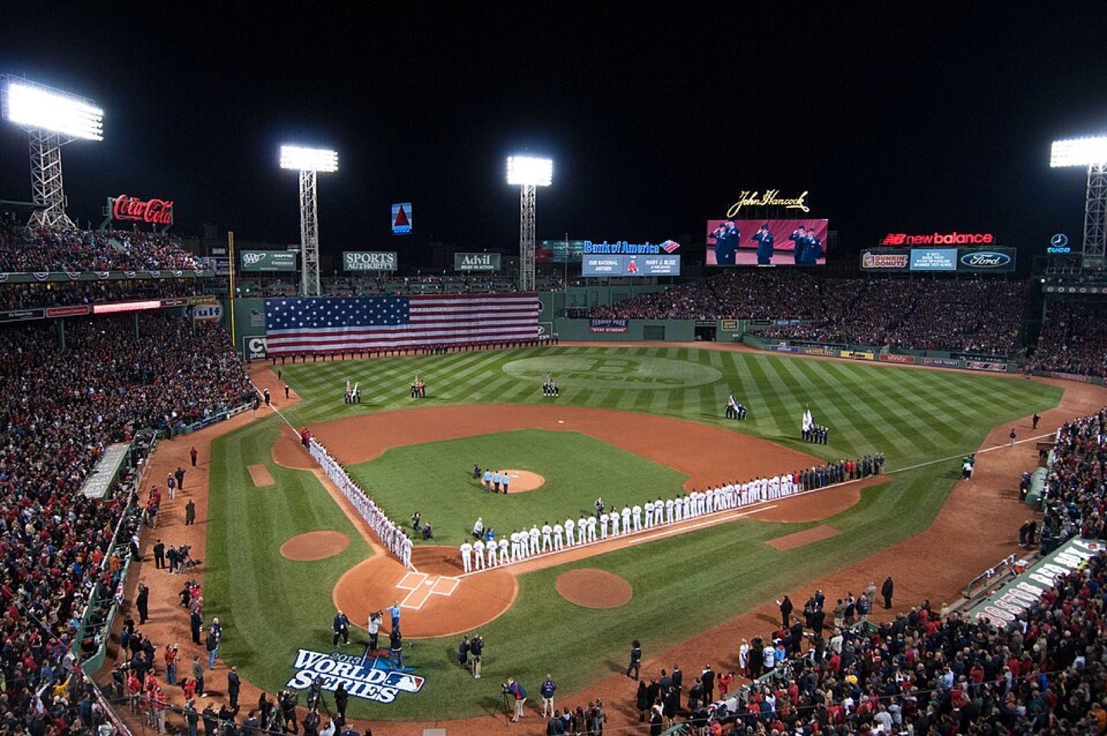 Fenway Park illuminated for a baseball game, viewed from the stands