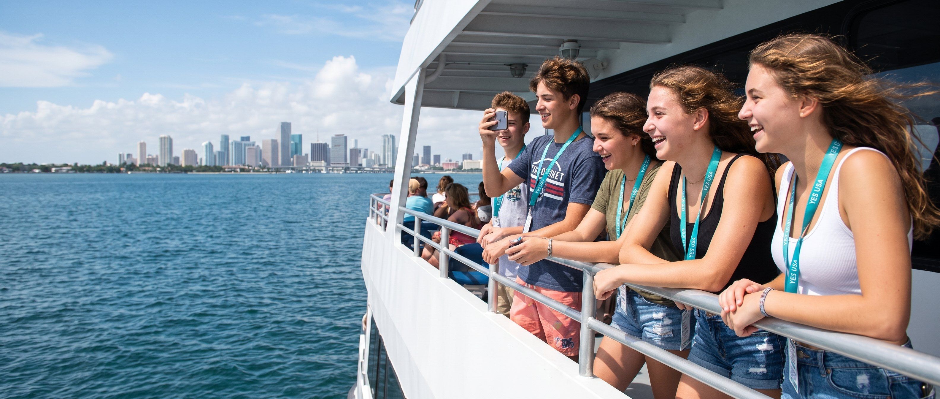 Students laughing at the Miami skyline from a boat on Biscayne Bay