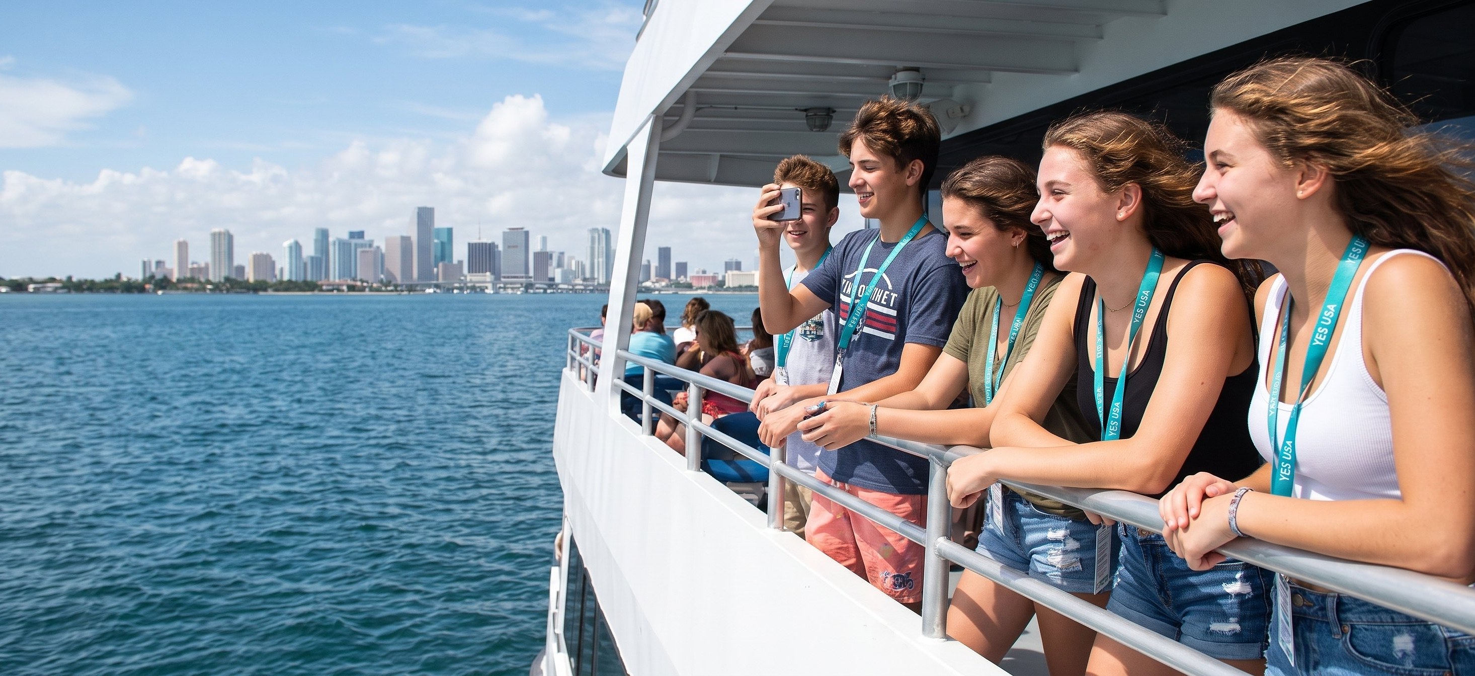Students laughing at the Miami skyline from a boat on Biscayne Bay