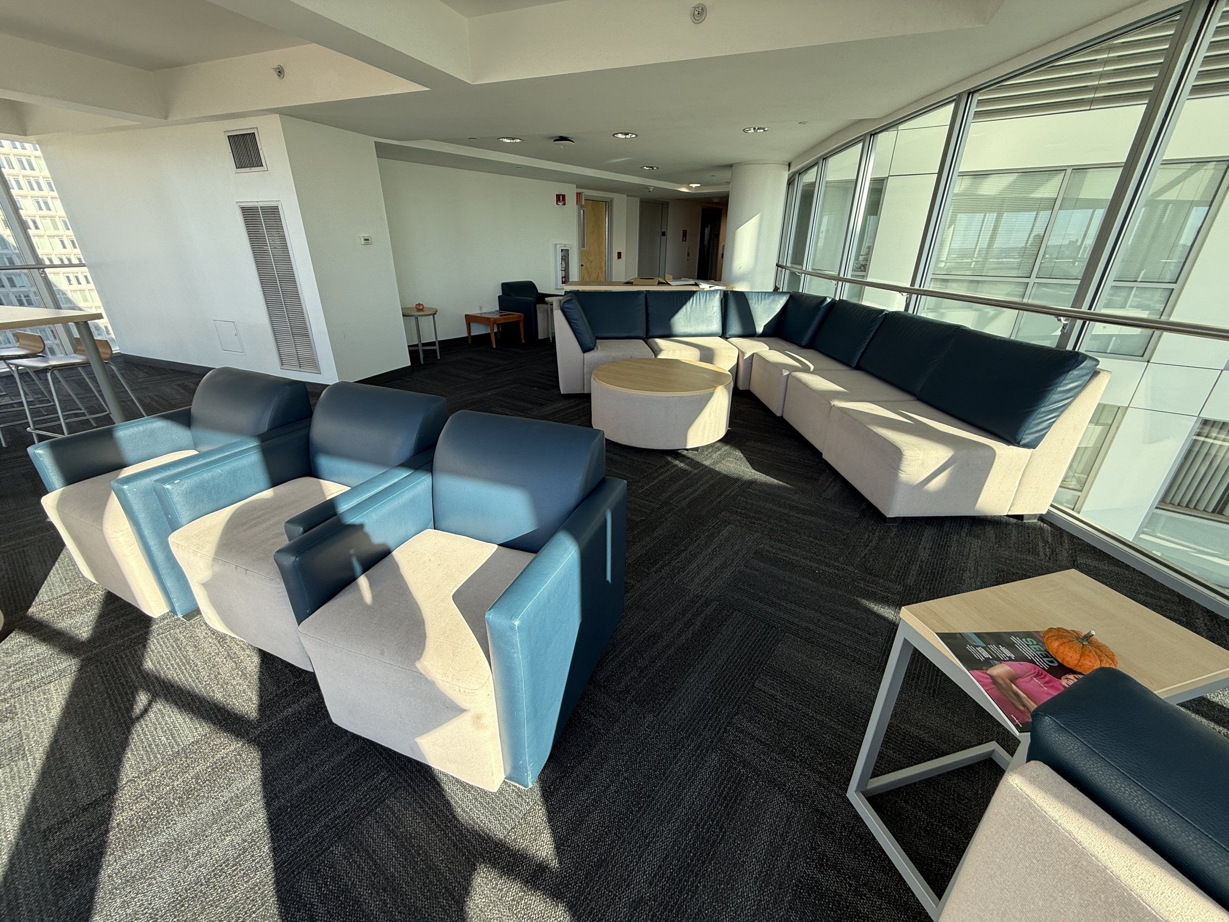 Residence lounge with blue sofas and floor-to-ceiling windows
