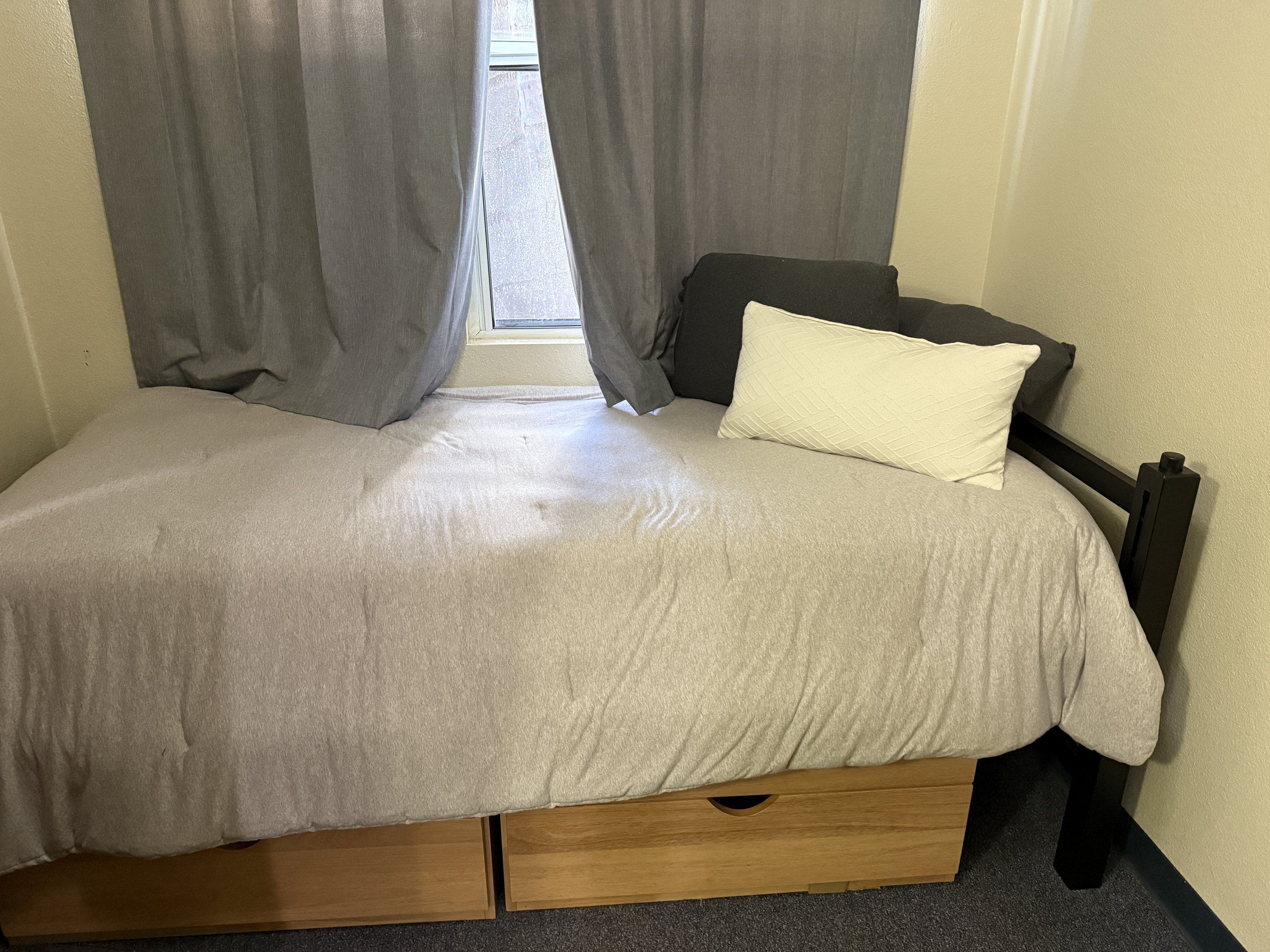 Residence bedroom with a bed and window at Concordia University Irvine