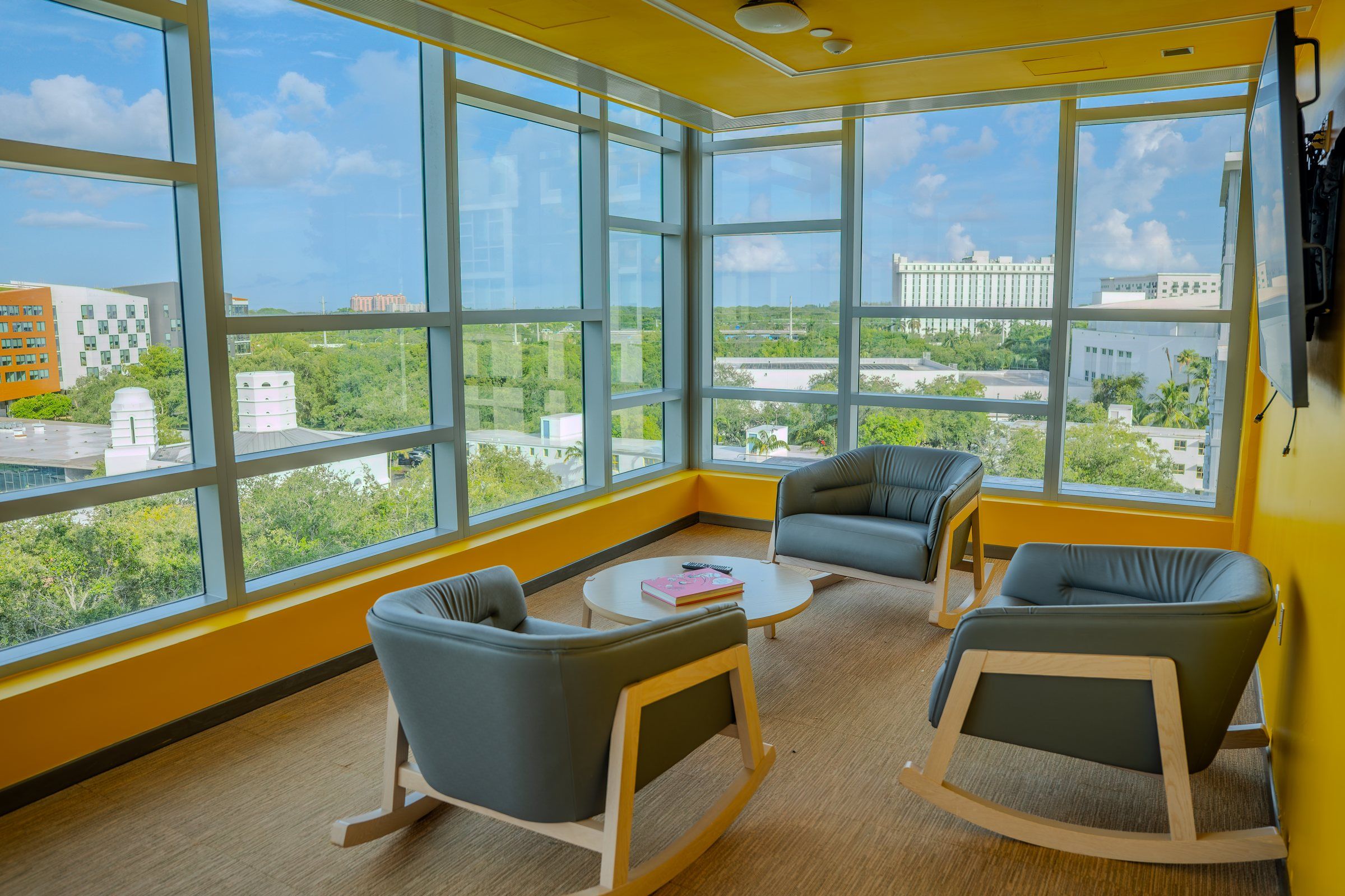 Corner lounge with armchairs and a panoramic view over campus