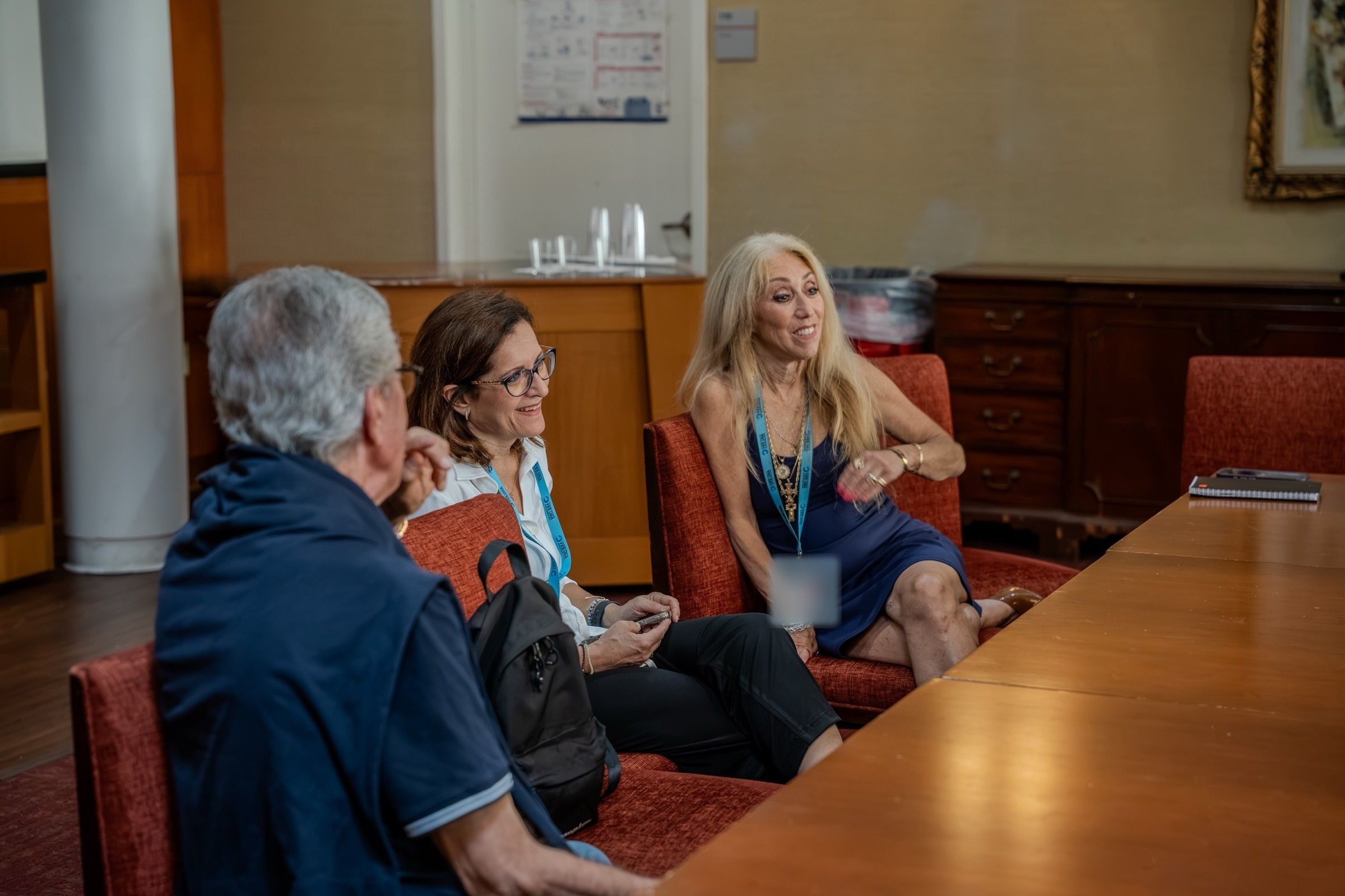 A YES USA manager talking with accompanying group leaders around a meeting table at St. John's University