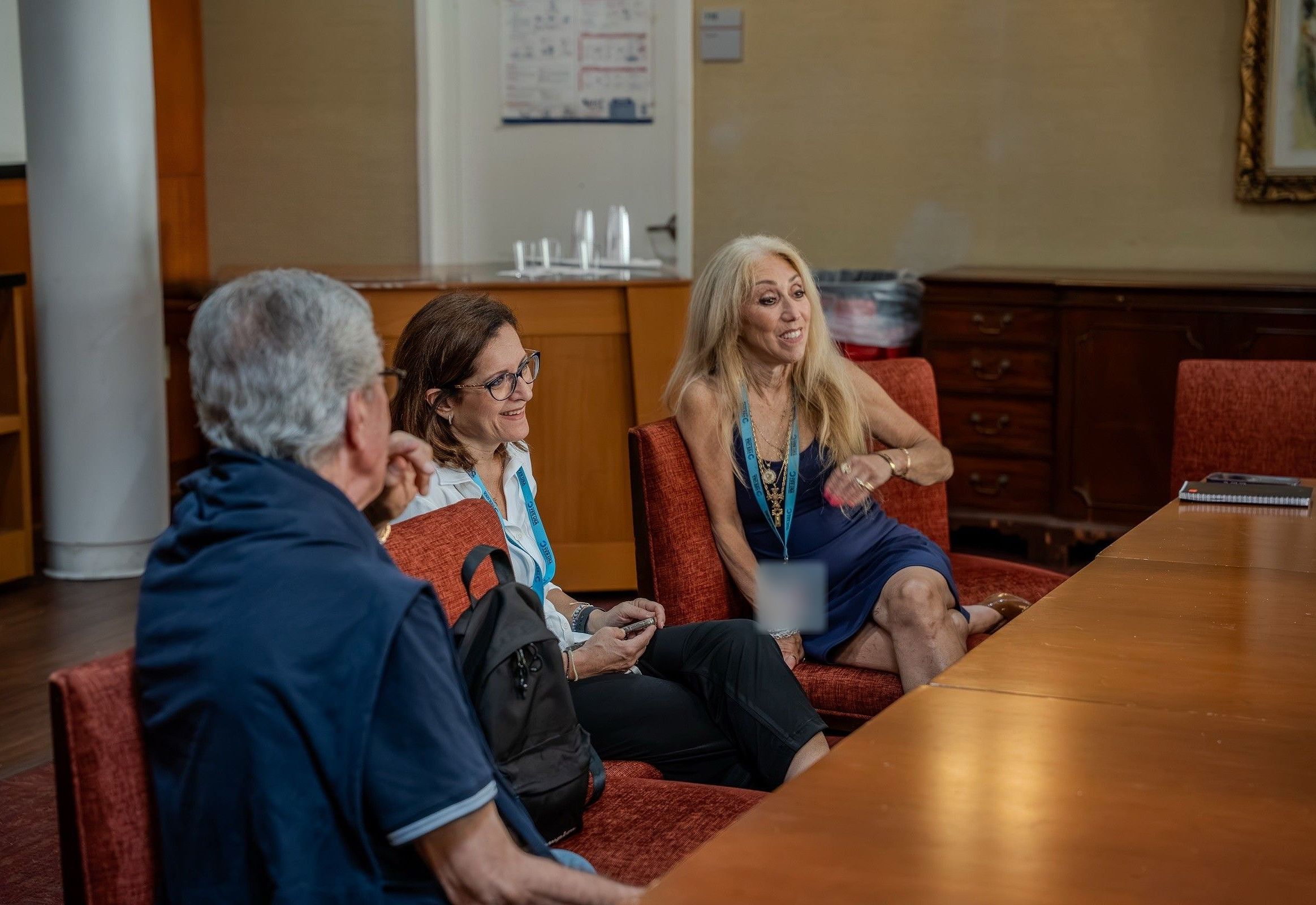 A YES USA manager talking with accompanying group leaders around a meeting table at St. John's University