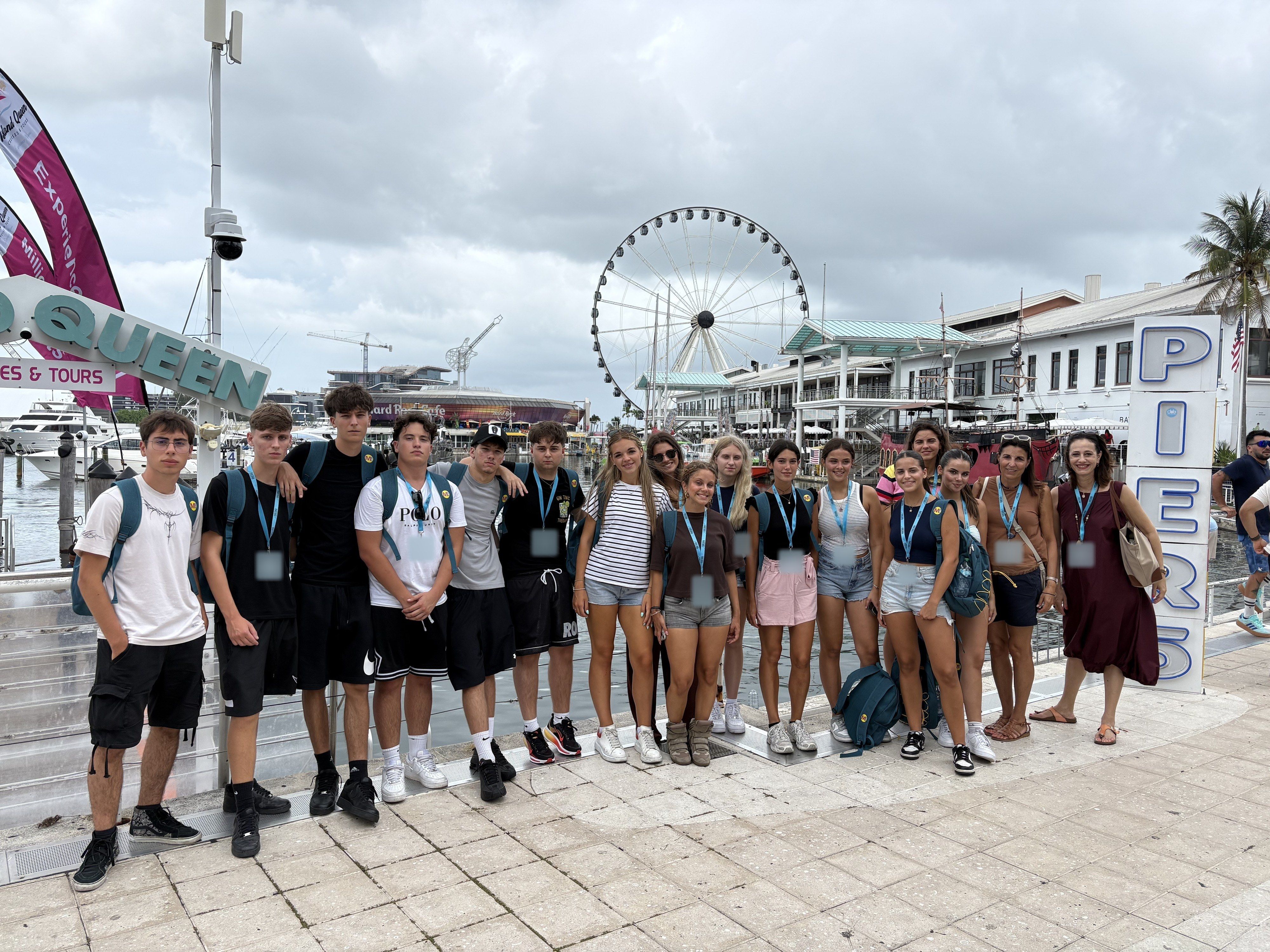 A large YES USA group at Bayside Marketplace, Miami, with the Ferris wheel behind